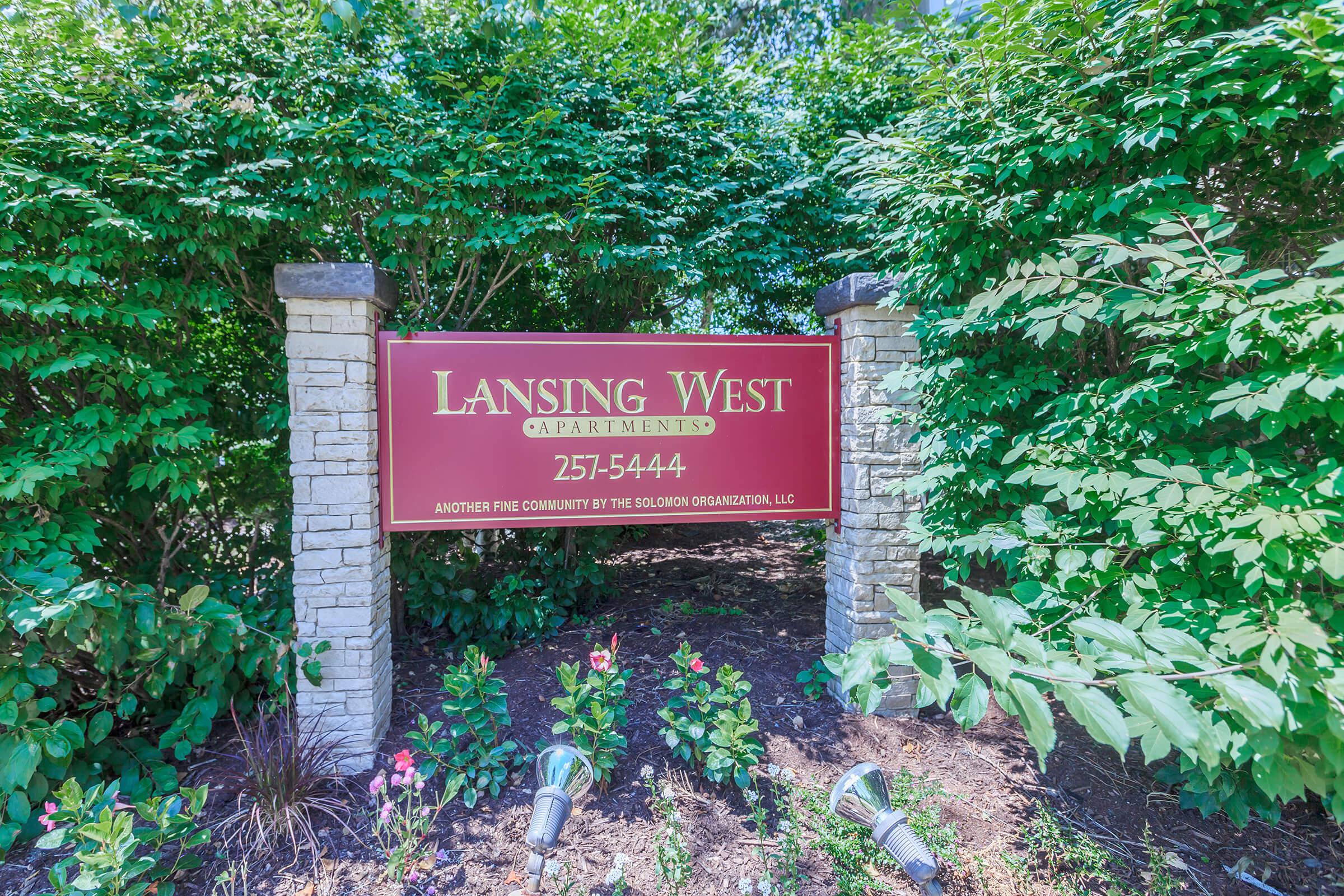 a sign in front of a tree