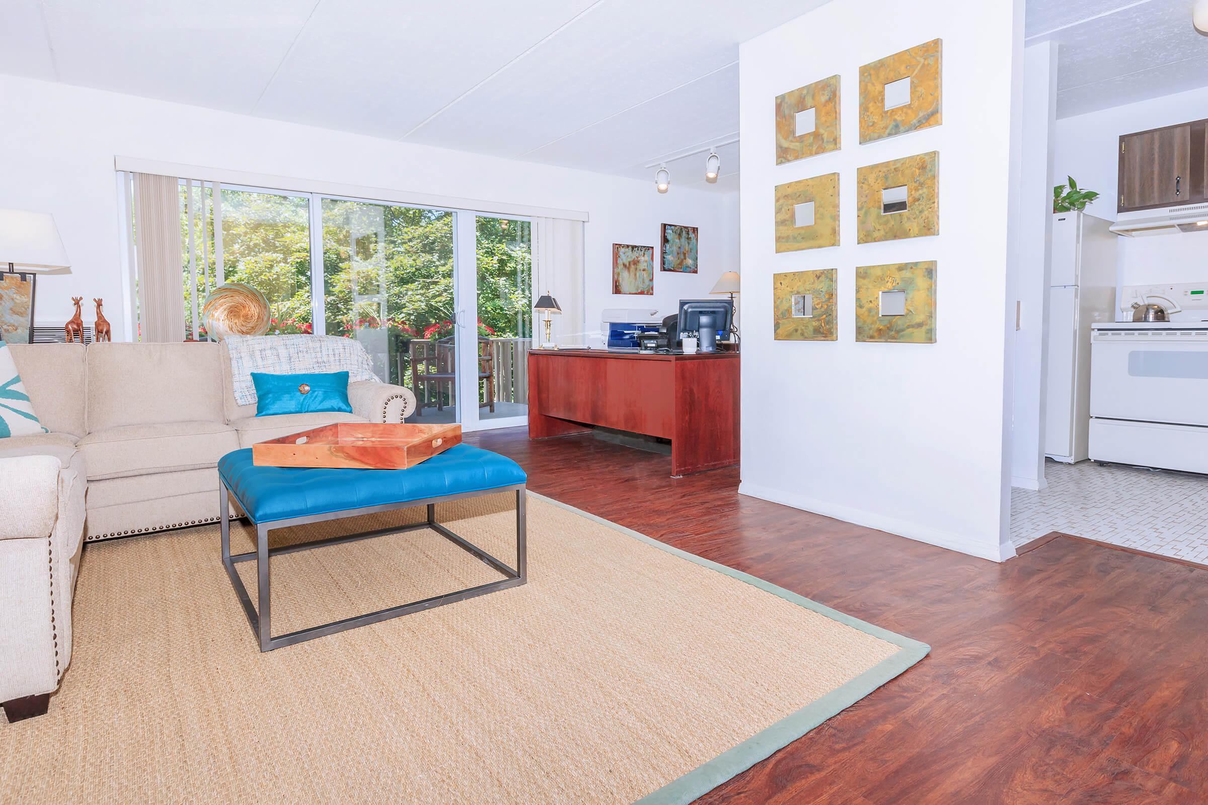 a living room filled with furniture and a large window