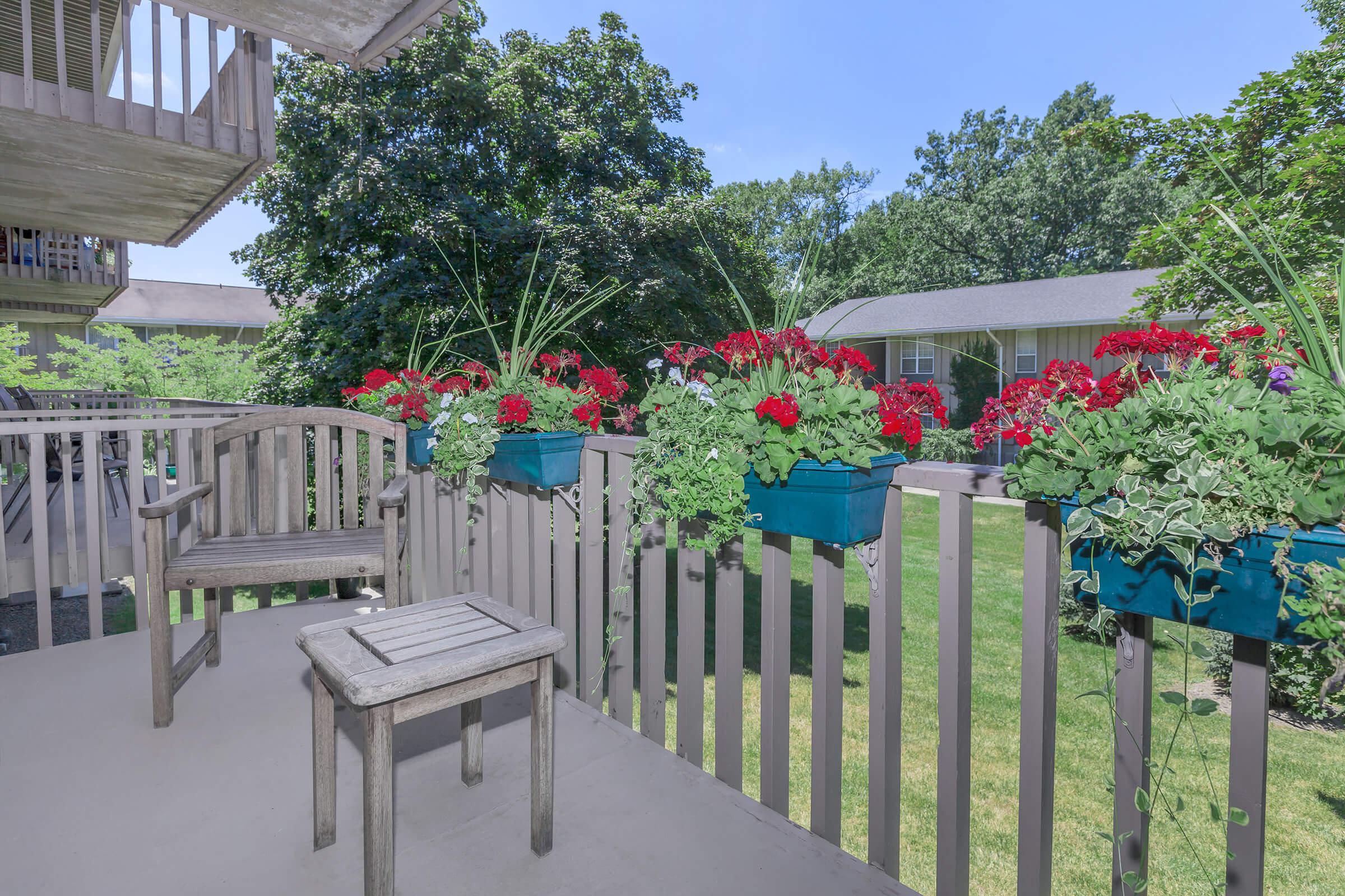 a group of lawn chairs sitting on top of a wooden fence