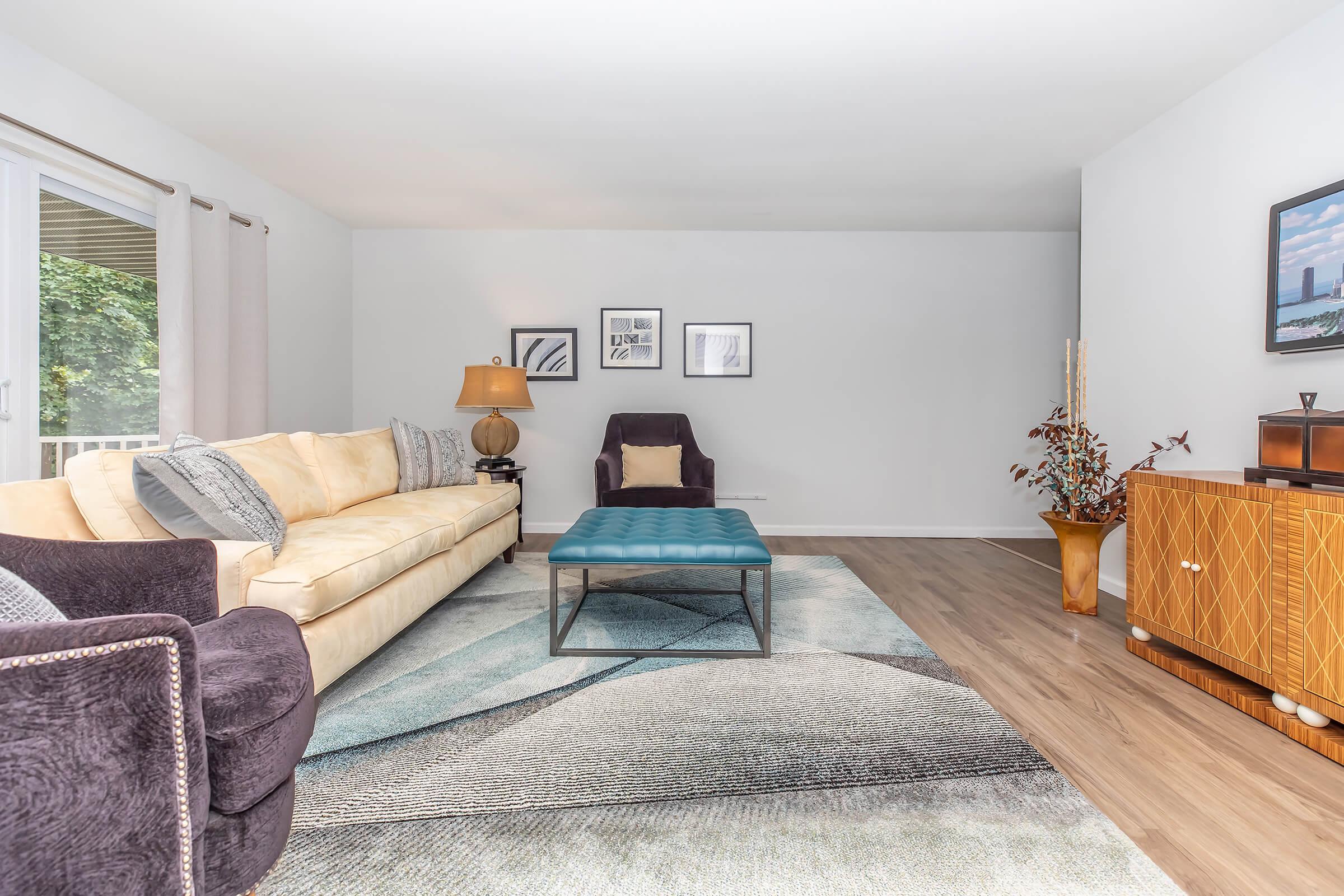 a living room filled with furniture and a large window