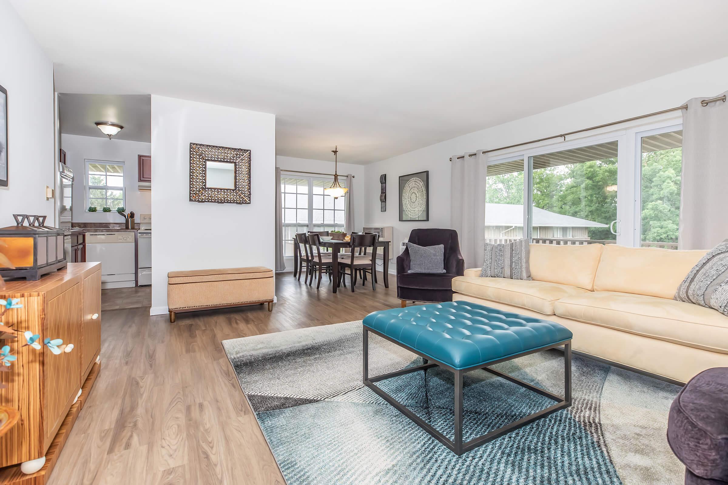 a living room filled with furniture and a large window