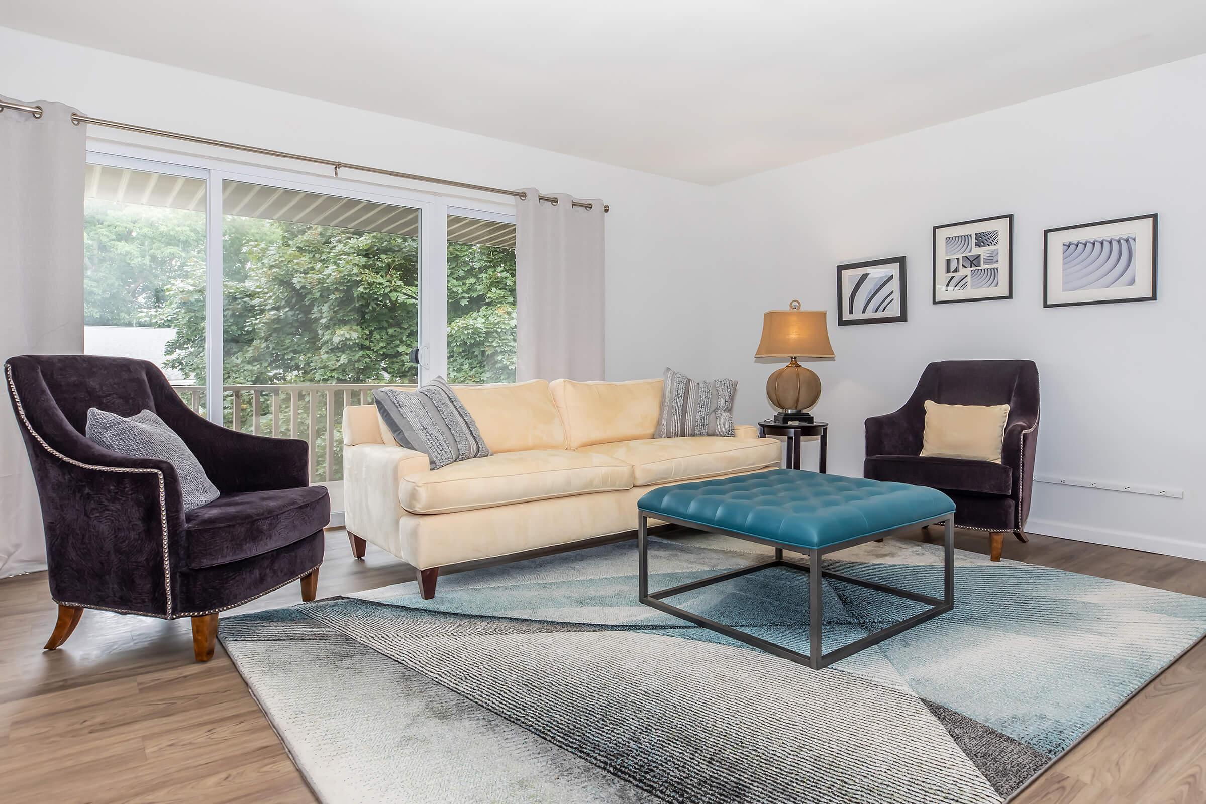 a living room filled with furniture and a large window