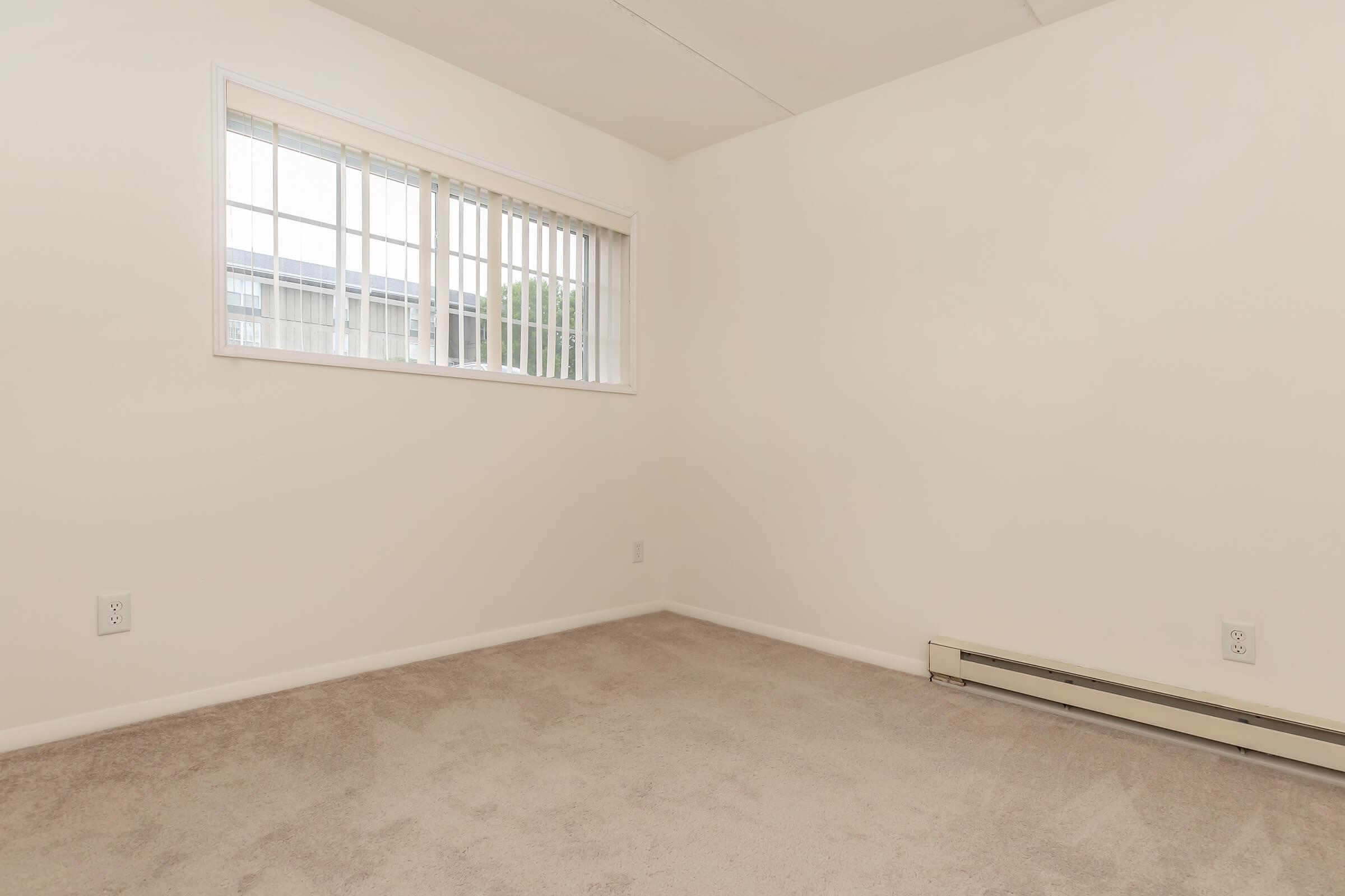 a bedroom with a large window