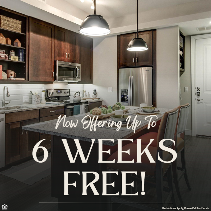 The Maxwell now offering up to 6 weeks free. Restrictions apply, please call for details. Image of an apartment kitchen with wood-style flooring, granite countertops, and stainless-steel appliances.
