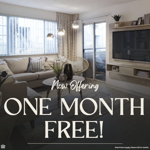 Photo of an apartment living room with a TV, couch, and windows. Now offering one month free! Restrictions apply, please call for details.