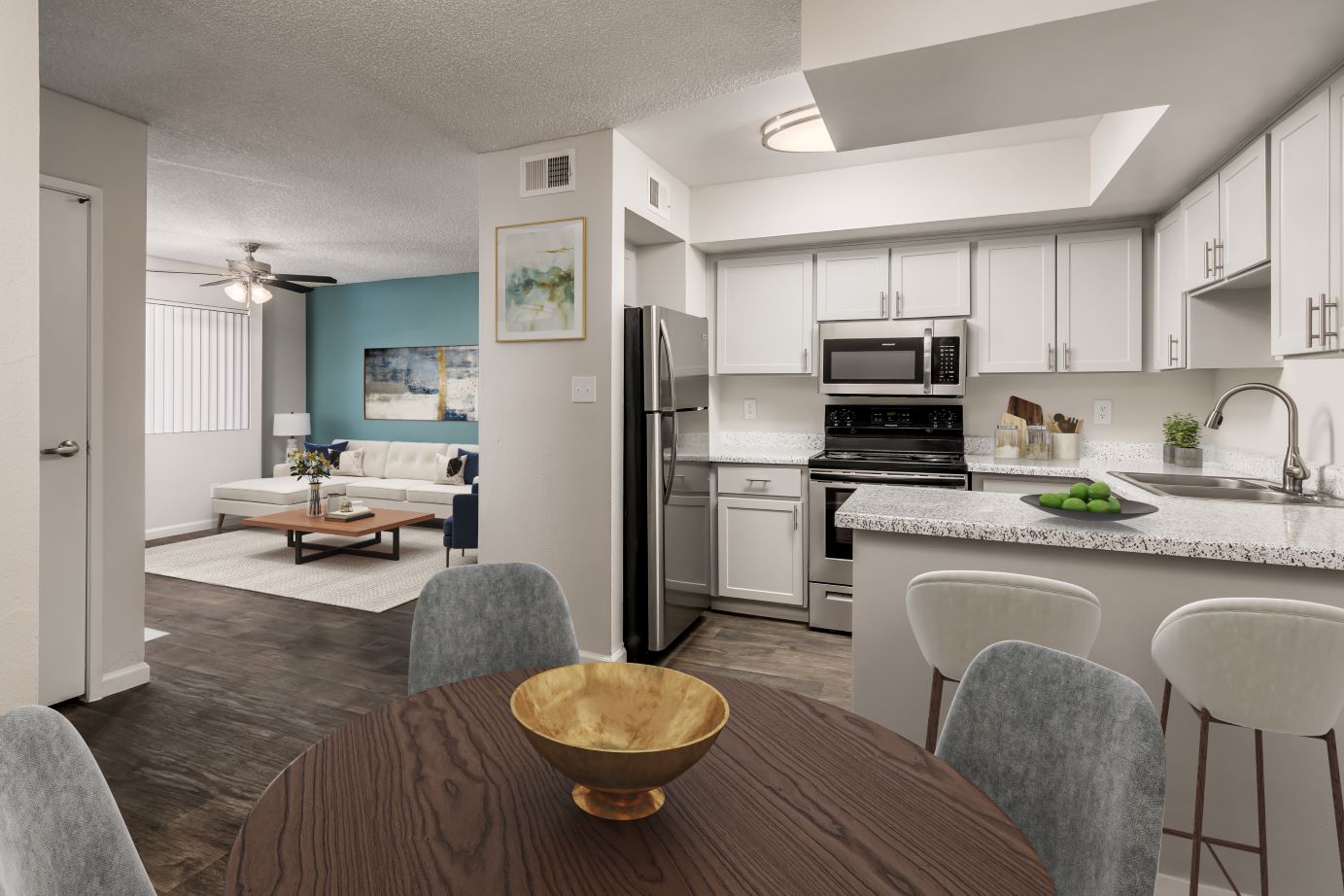 A kitchen and dining area with a table and chairs at Coral Point Apartments in Mesa, AZ