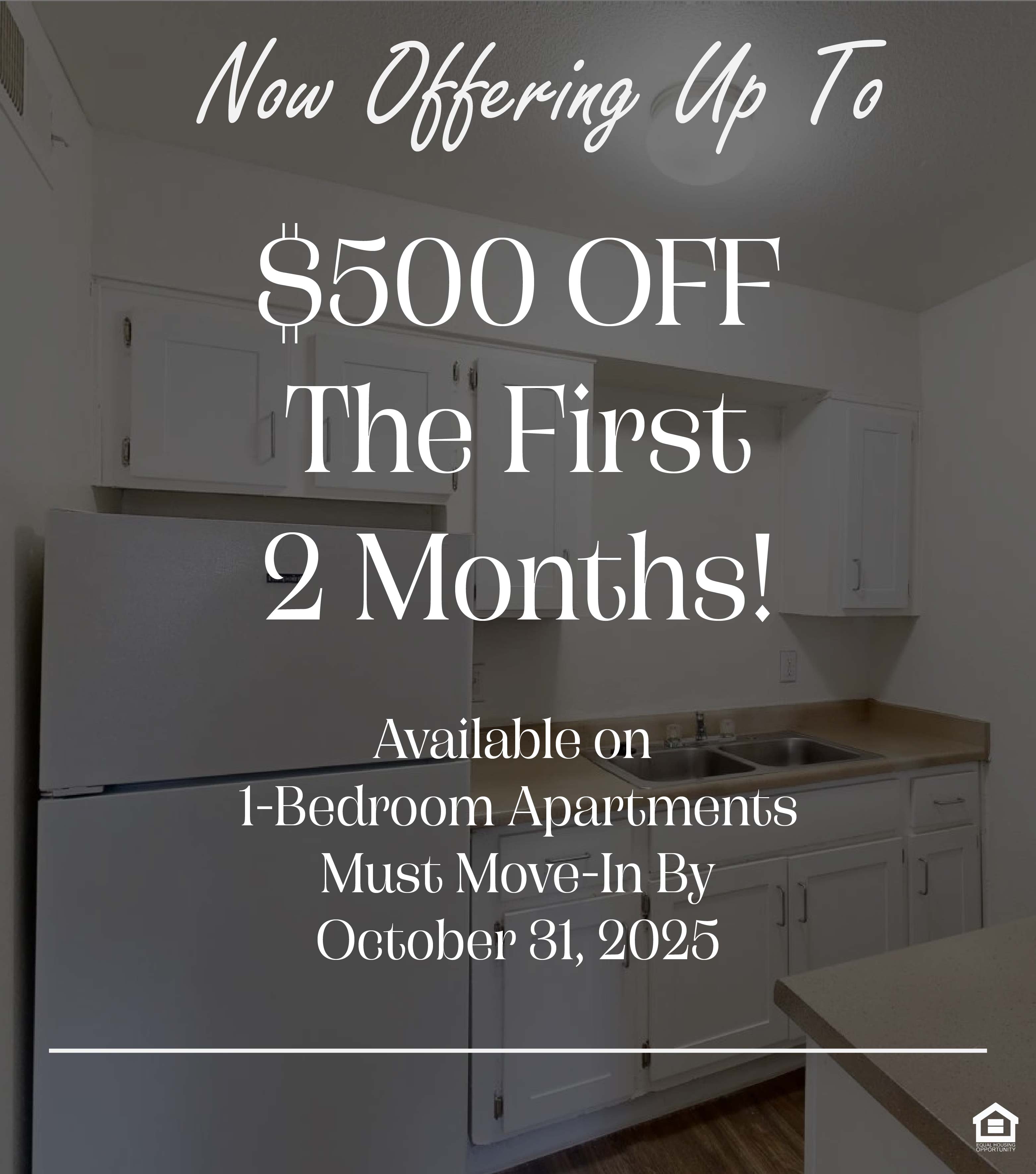A small kitchen featuring white cabinets, a countertop, a stainless steel sink, and a refrigerator. The walls are light-colored, and the floor appears to be a wood laminate. A ceiling light illuminates the space. The text on the image says, "Now Offering Up To $500 OFF The First 2 Months! Available on 1-Bedroom Apartments. Must Move-In by October 31, 2025.