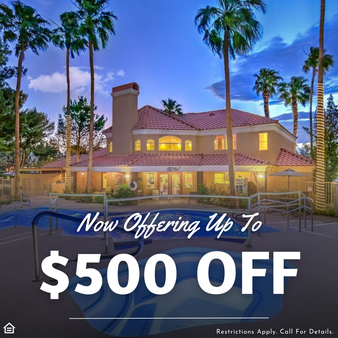 Exterior view of a luxury apartment community at dusk with tall palm trees, a large clubhouse featuring warm lights and a red tile roof, and a pool with a spa in the foreground. Text overlay reads “Now Offering Up To $500 OFF” in bold white letters. A small note at the bottom states, “Restrictions Apply. Call For Details.”