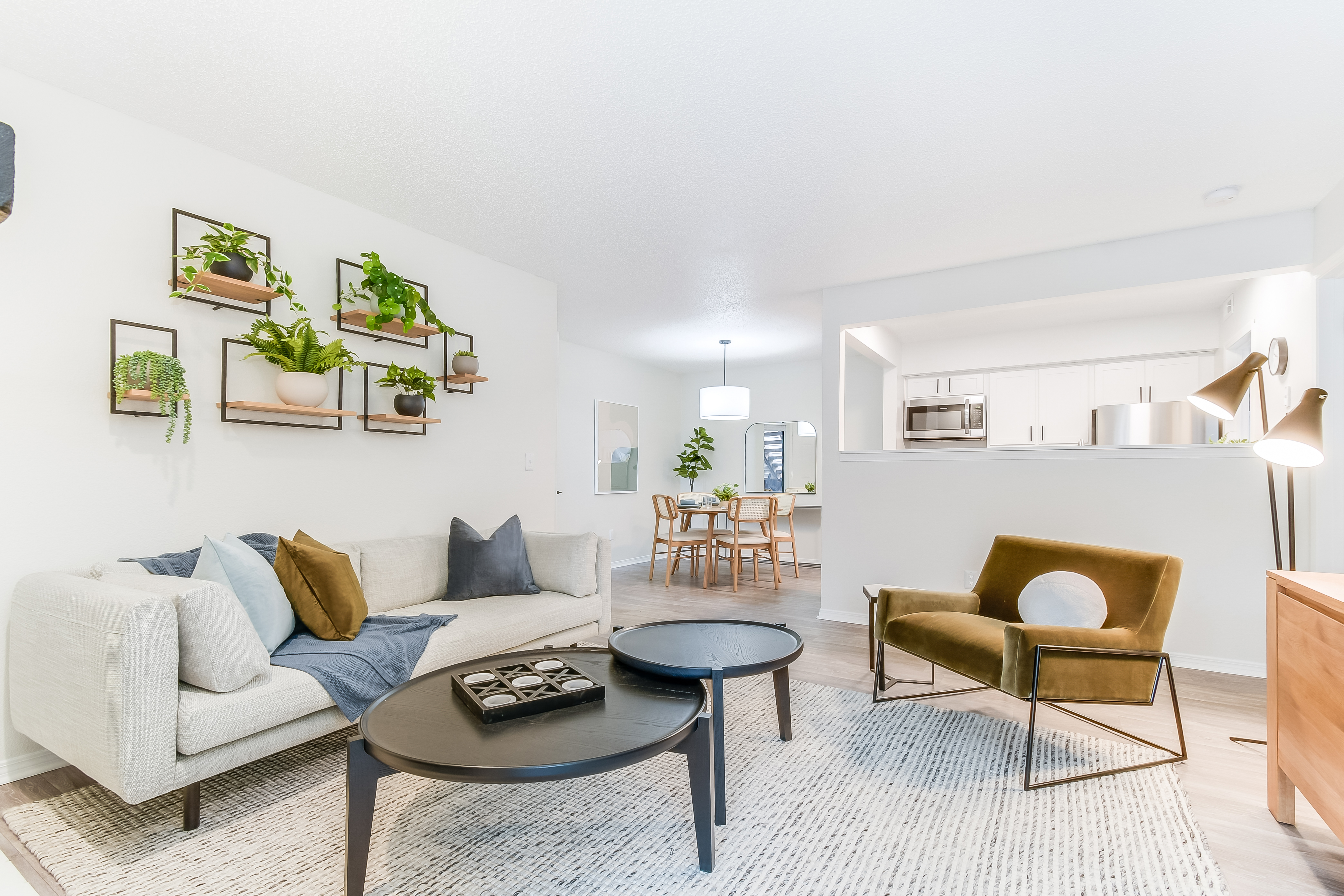 A living room with a couch and a table at Dylan Apartments in Kansas City, KS