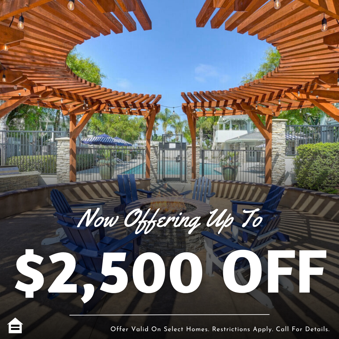 Outdoor community seating area with wooden pergolas and a round fire pit surrounded by blue Adirondack chairs, with a pool and palm trees in the background. Overlaid text reads: “Now Offering Up To $2,500 OFF.” Small print at the bottom states: “offer valid on select homes. Restrictions Apply. Call For Details.”