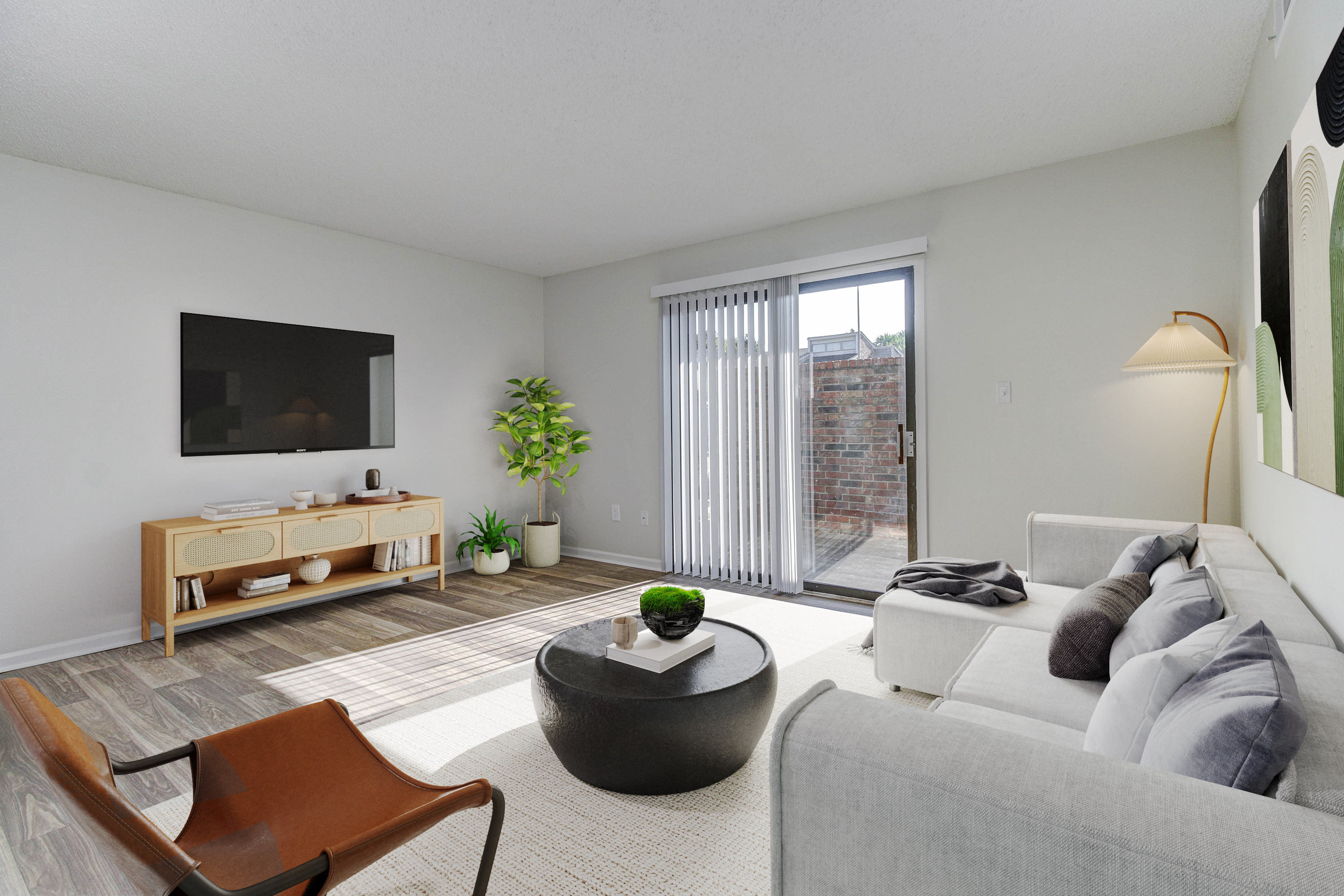 A living room with a TV and a couch at Ramsgate Apartments and Townhomes in Olathe, Kansas
