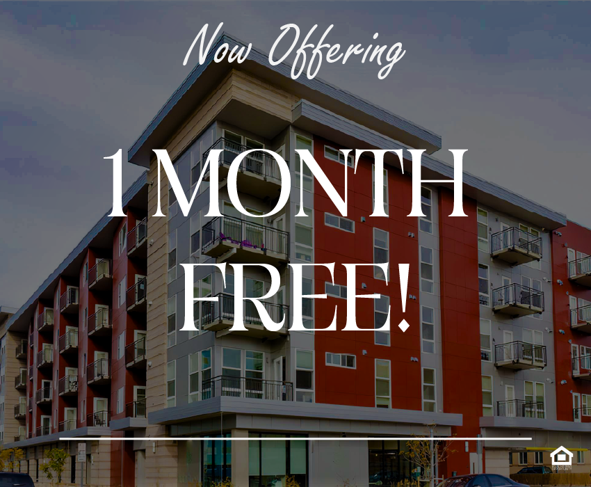 Modern apartment building with a combination of red and gray exterior. It features multiple balconies on each floor, large windows on the ground floor, and a contemporary architectural design. The surrounding area appears urban and well-maintained. The text on the image says, "Now offering 1 month free!"