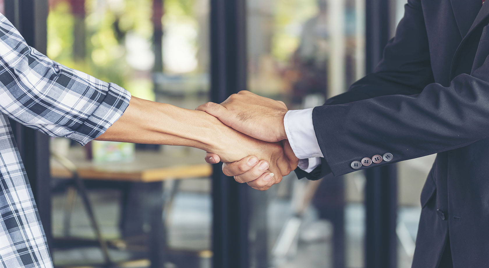 A close-up of two people shaking hands