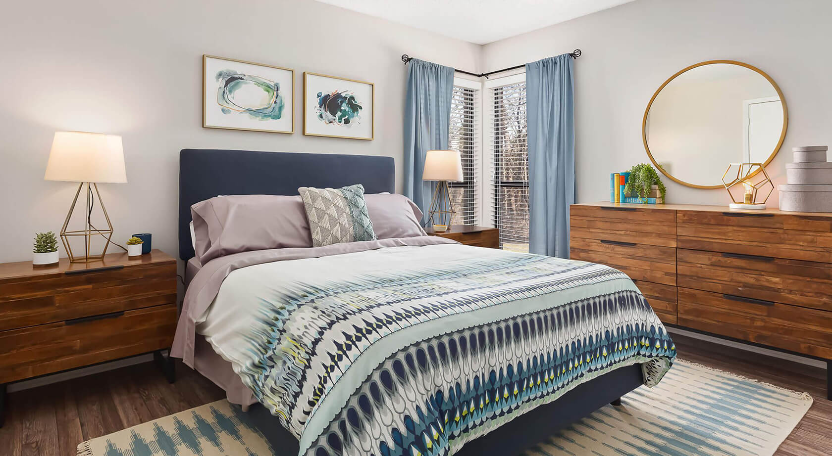 A bedroom with a bed and a dresser at Huntsview Apartments in Greensboro, NC