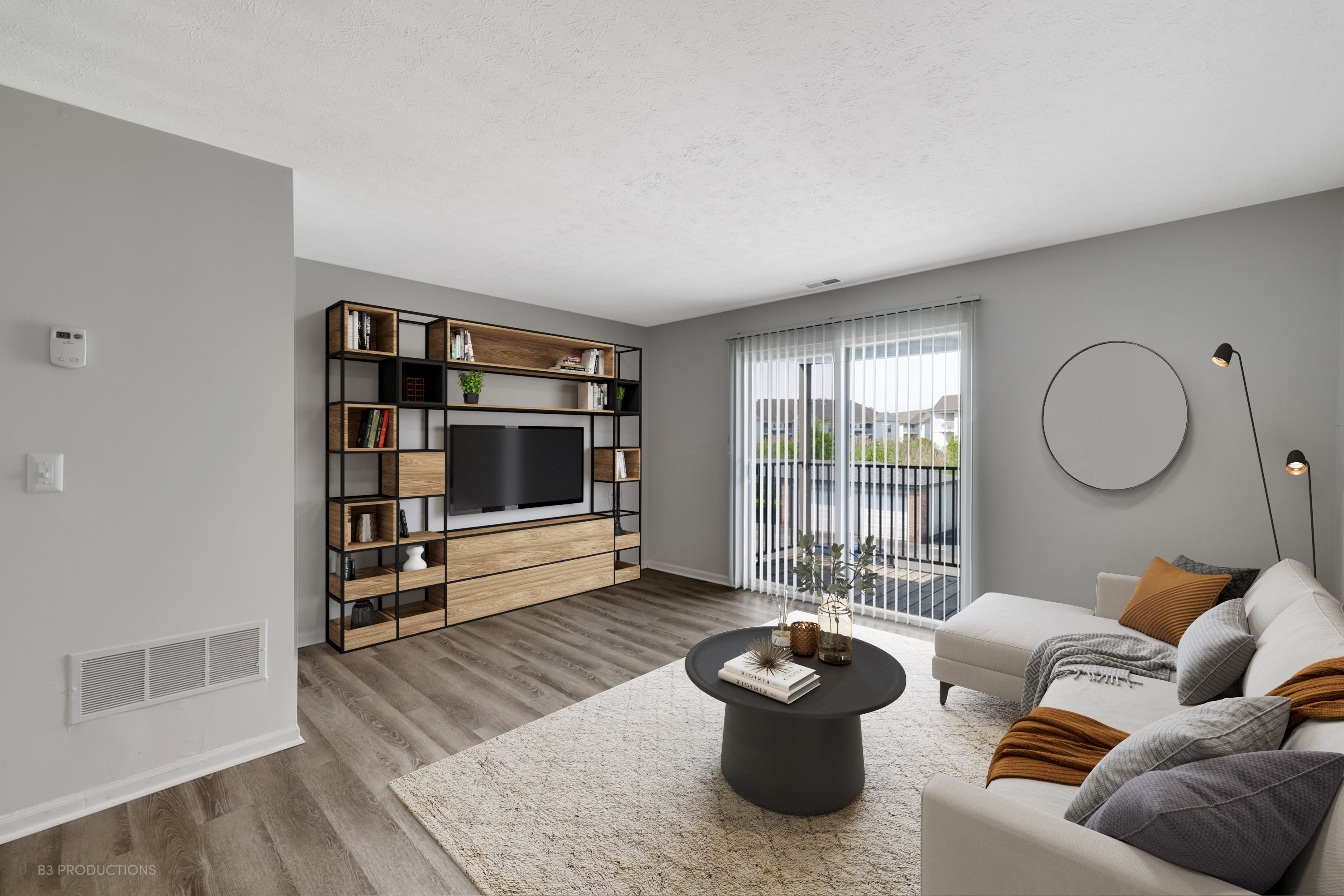 A living room with a TV and couch at Port Crossing Apartments in Portage, Indiana