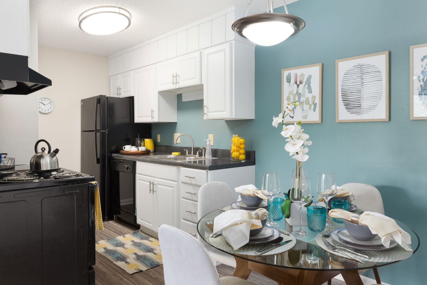 A kitchen with a table and refrigerator at Edgewater Village Apartments in Greensboro, NC