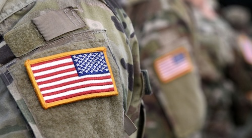 A close-up of an American flag on a military uniform