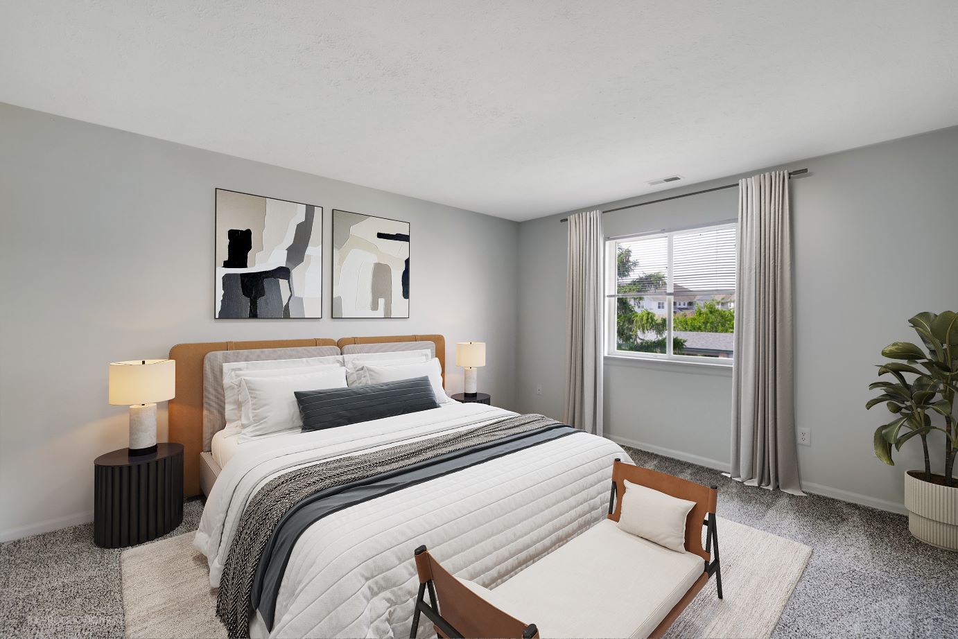 A bedroom with a bed and a bench at Lakeview Apartments in Franklin, Indiana