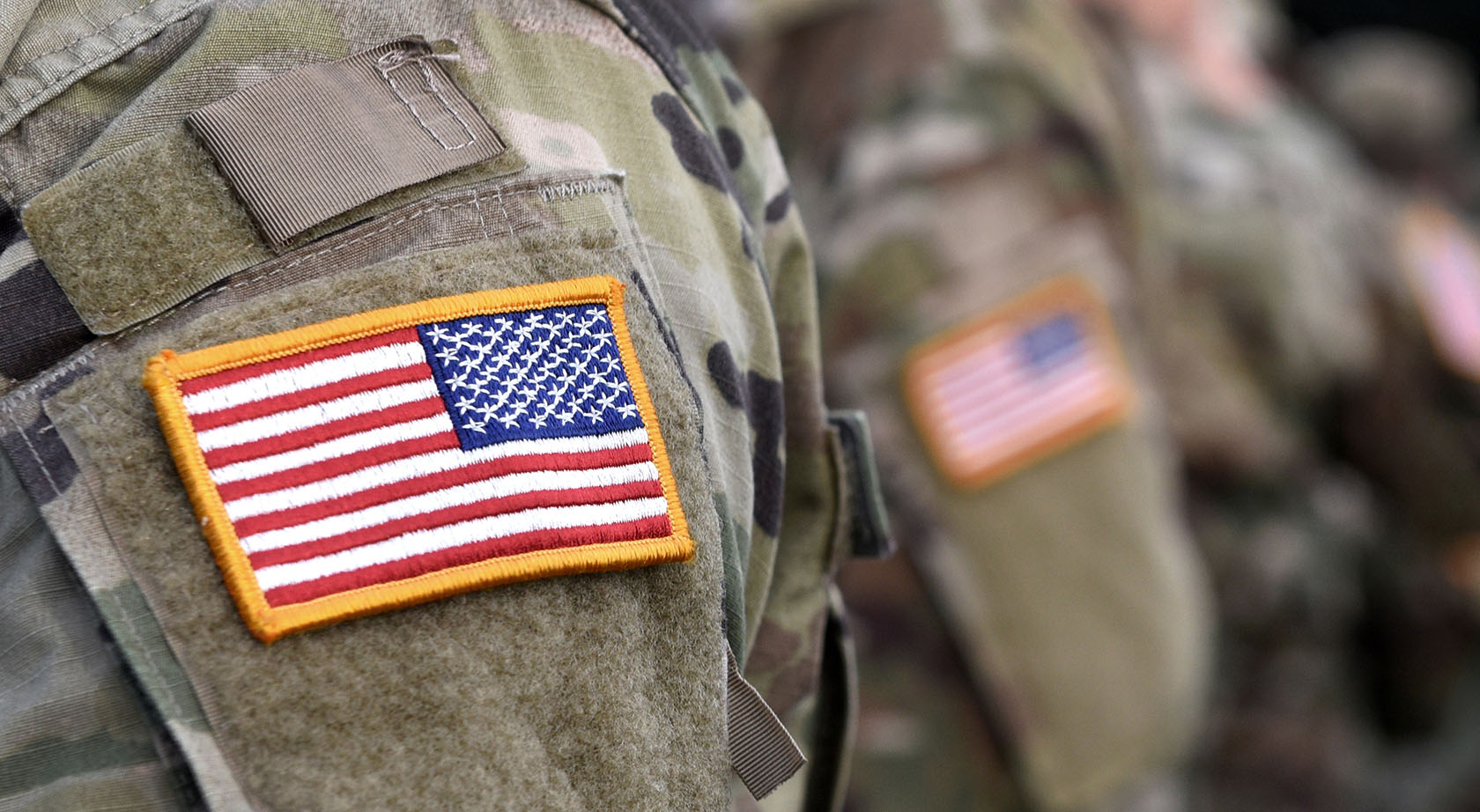 A close-up of an American flag on a military uniform
