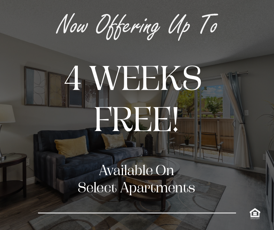 A cozy living room featuring a dark sofa with yellow cushions, a glass coffee table on a patterned rug, and a lamp. The text on the image says, "Now offering up to 4 weeks free! Available on select apartments."