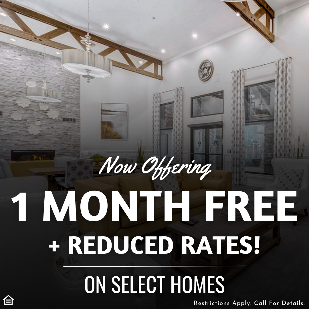 Promotional graphic featuring a bright, modern apartment community lounge with high ceilings, exposed wooden beams, and stylish lighting. Text overlay reads: “Now Offering 1 Month Free + Reduced Rates! On Select Homes.” Small print at the bottom says, “Restrictions Apply. Call For Details.”