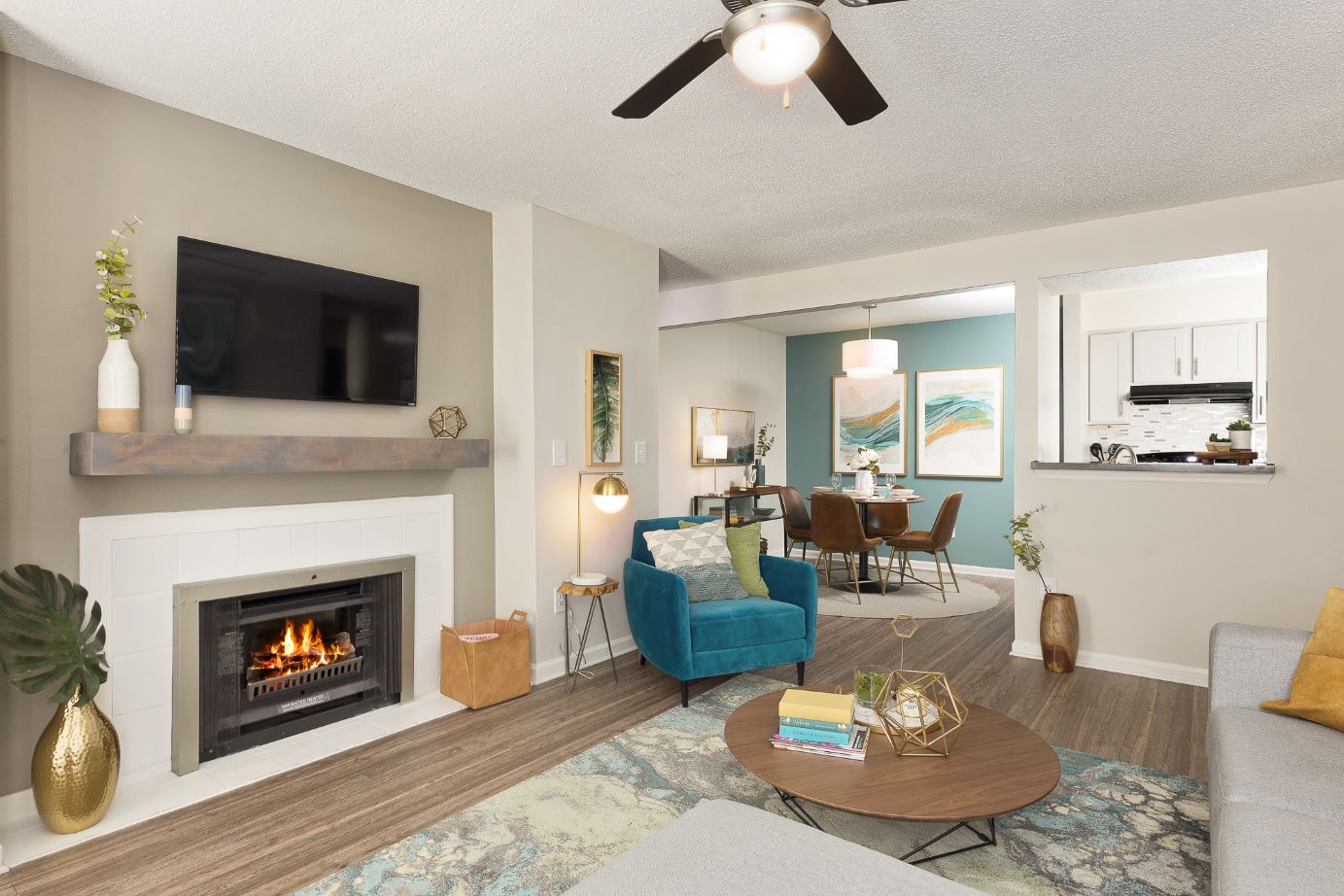 A living room with a fireplace and a tv at Huntsview Apartments in Greensboro, NC