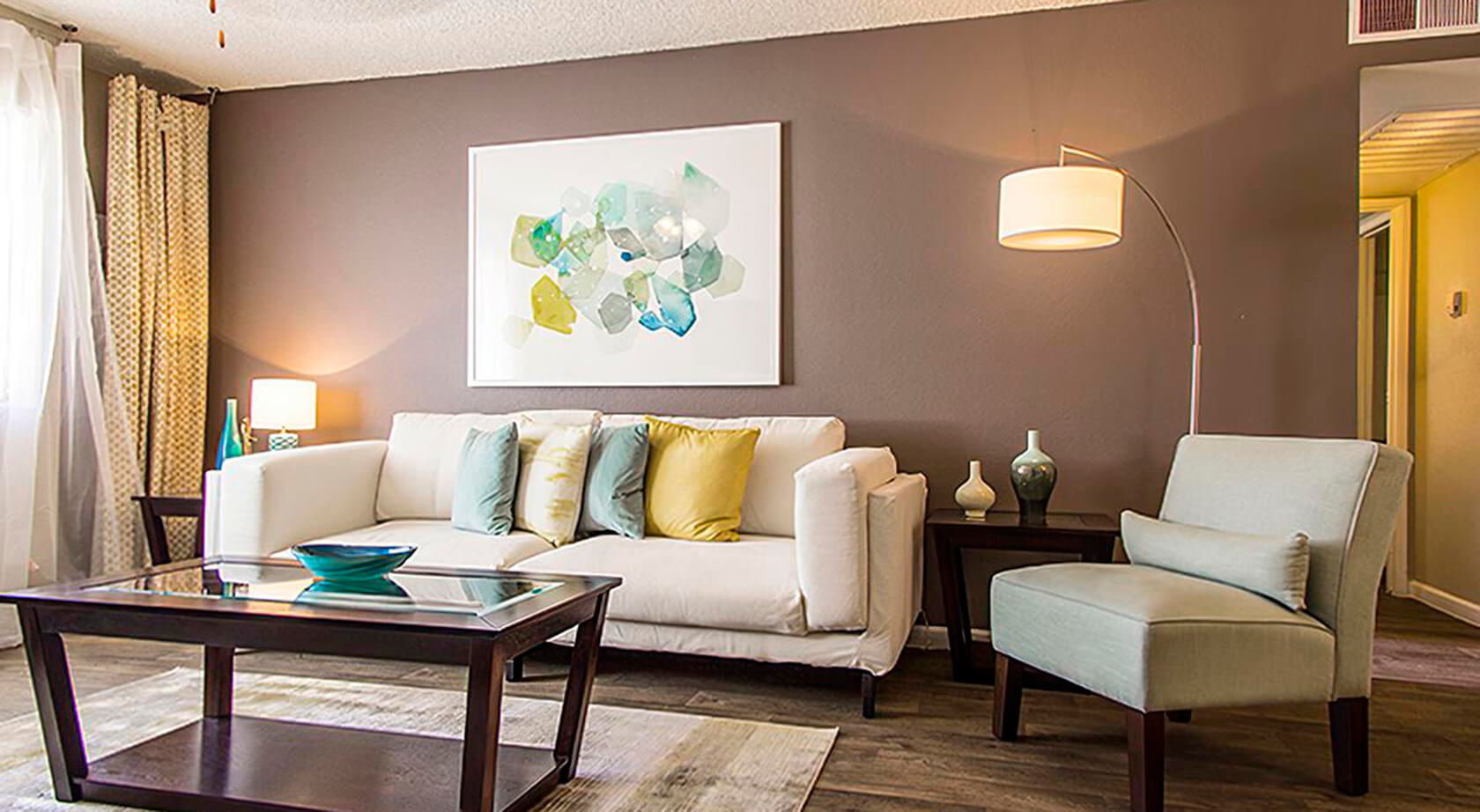 A living room with a couch and a coffee table at Coral Point Apartments in Mesa, AZ