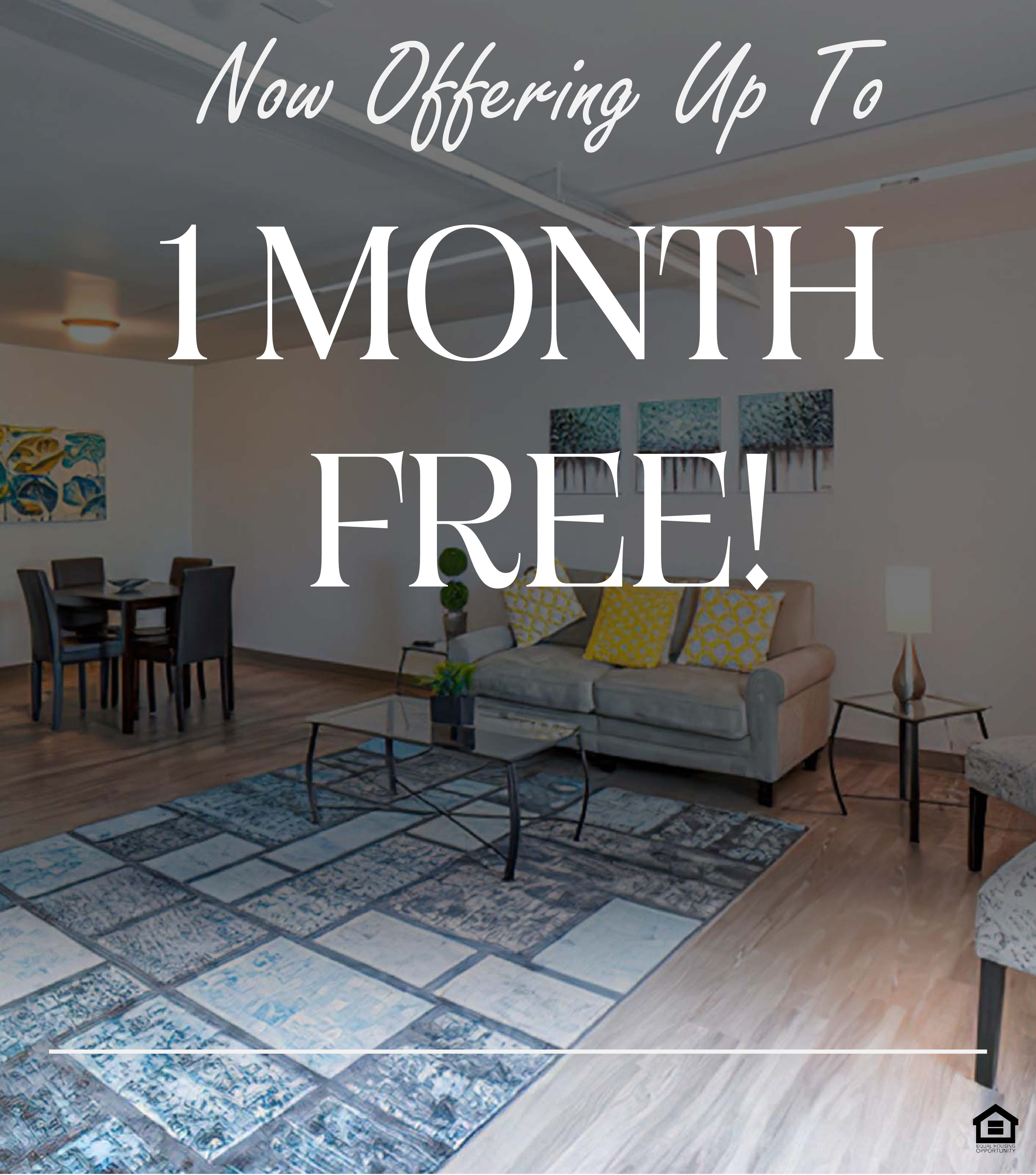 A modern, well-lit living room featuring a gray couch with colorful throw pillows, a glass coffee table, and a patterned area rug. There is a small dining area with a table and chairs in the background, along with vibrant wall art depicting abstract landscapes. The text on the image says "Now offering up to 1 month free!"