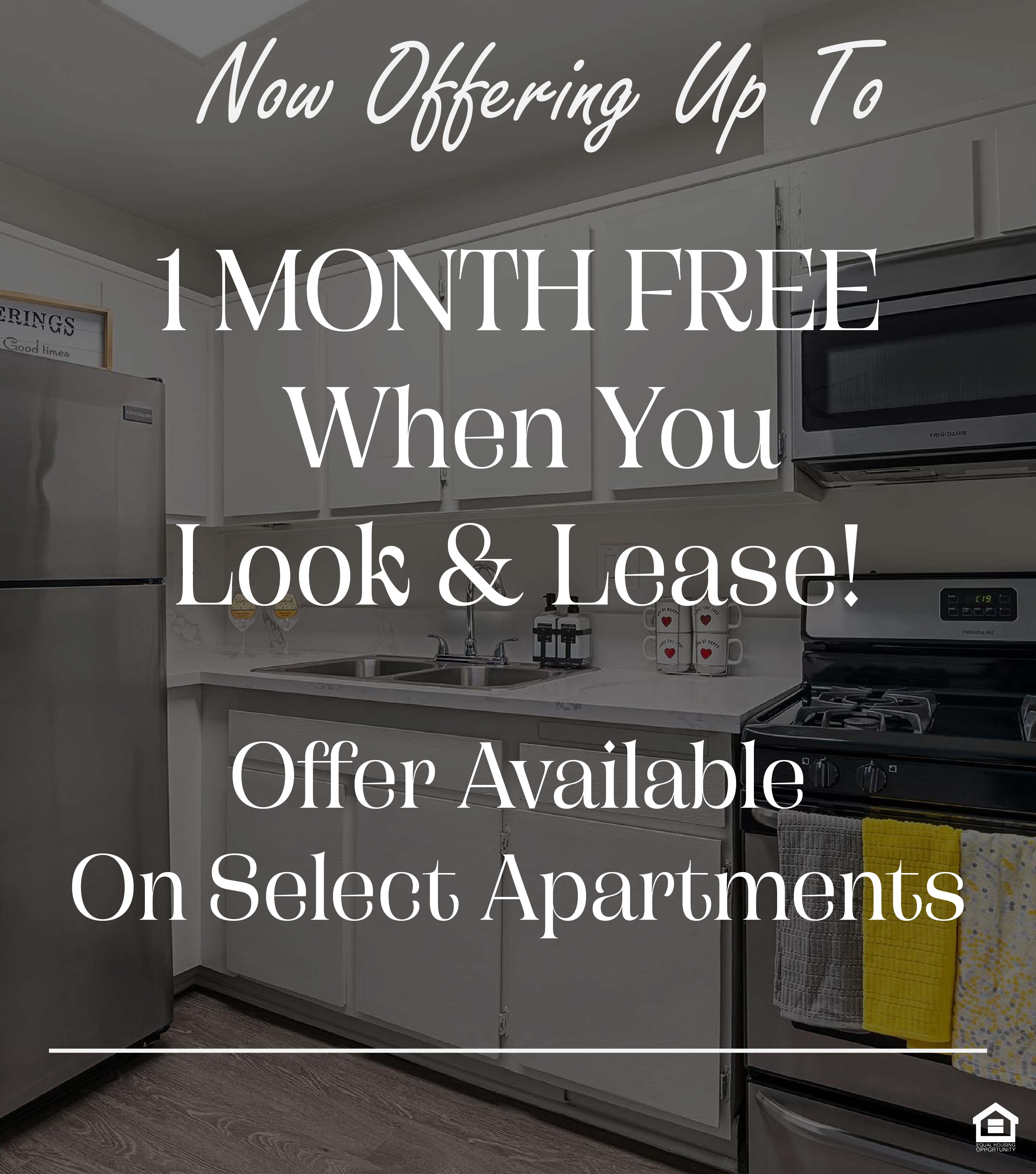 A kitchen with a stove top oven and microwave. The text on the image says, "Now offering up to 1 month free when you look & lease! Offer available on select apartments."
