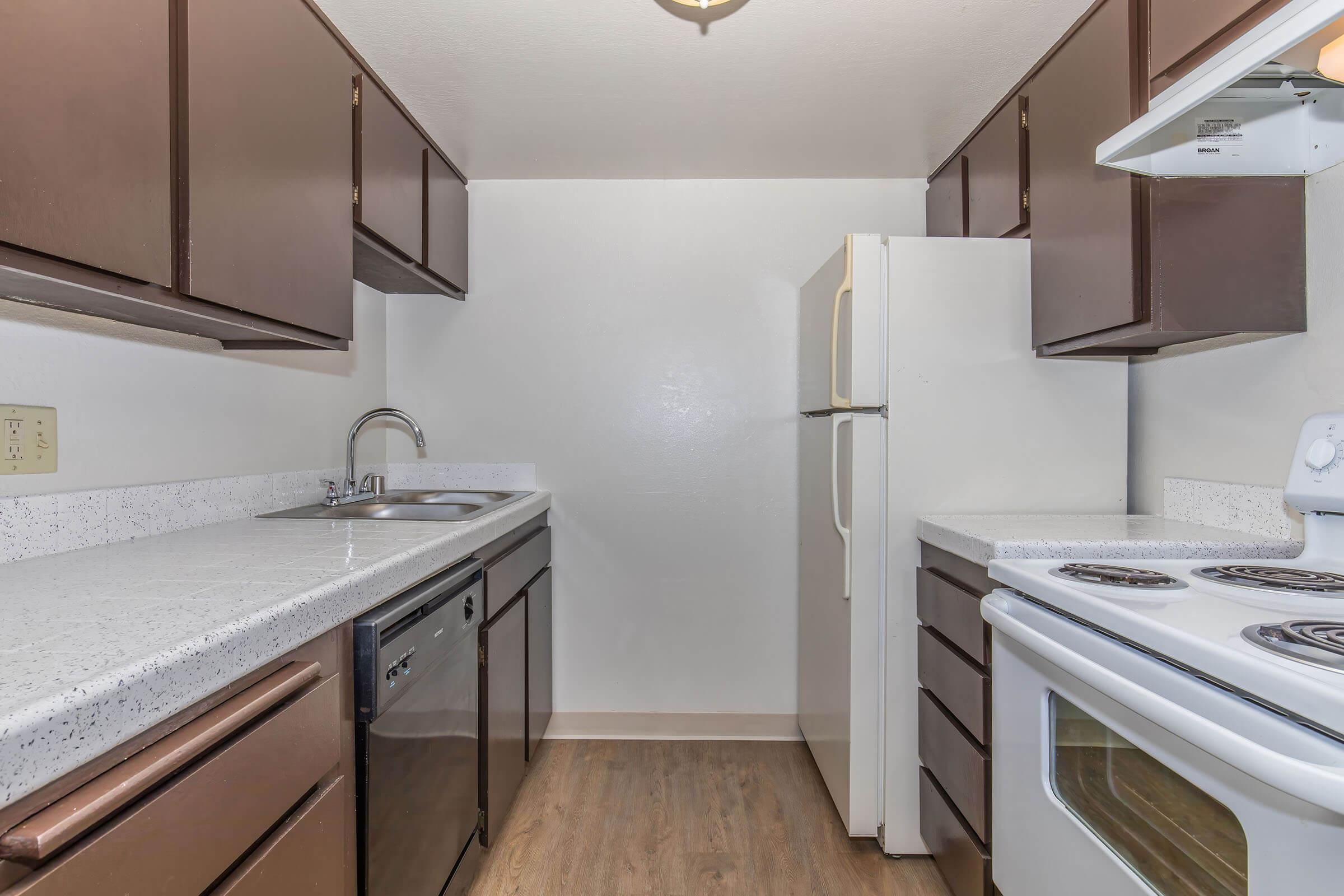 a kitchen with a sink and a mirror