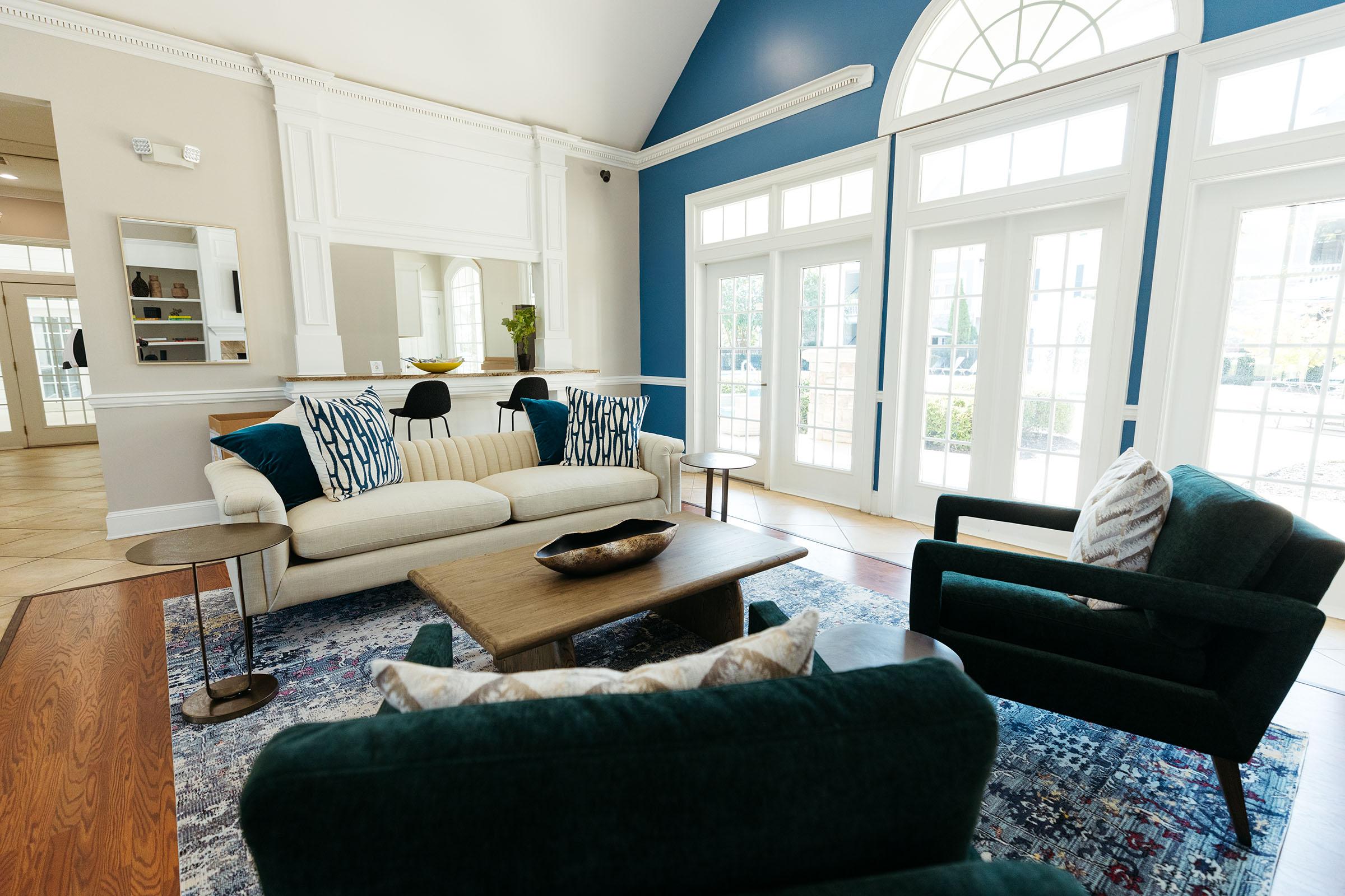 a living room filled with furniture and a large window