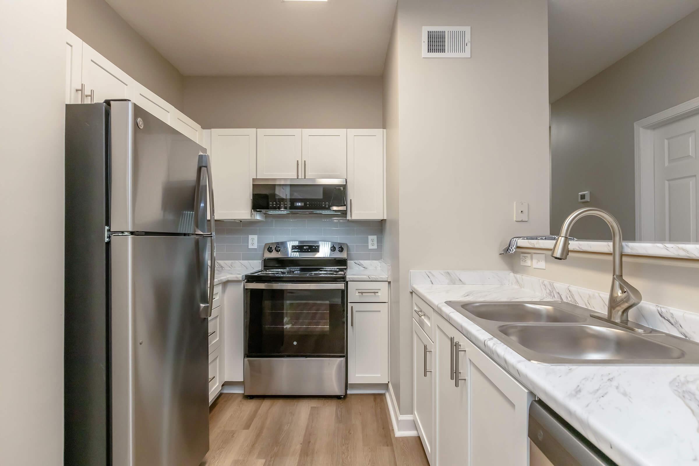 a large kitchen with stainless steel appliances