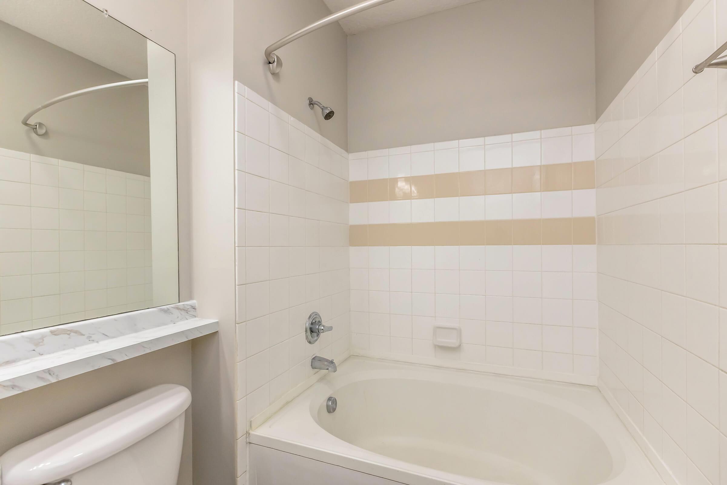 a sink and a white tub sitting next to a shower