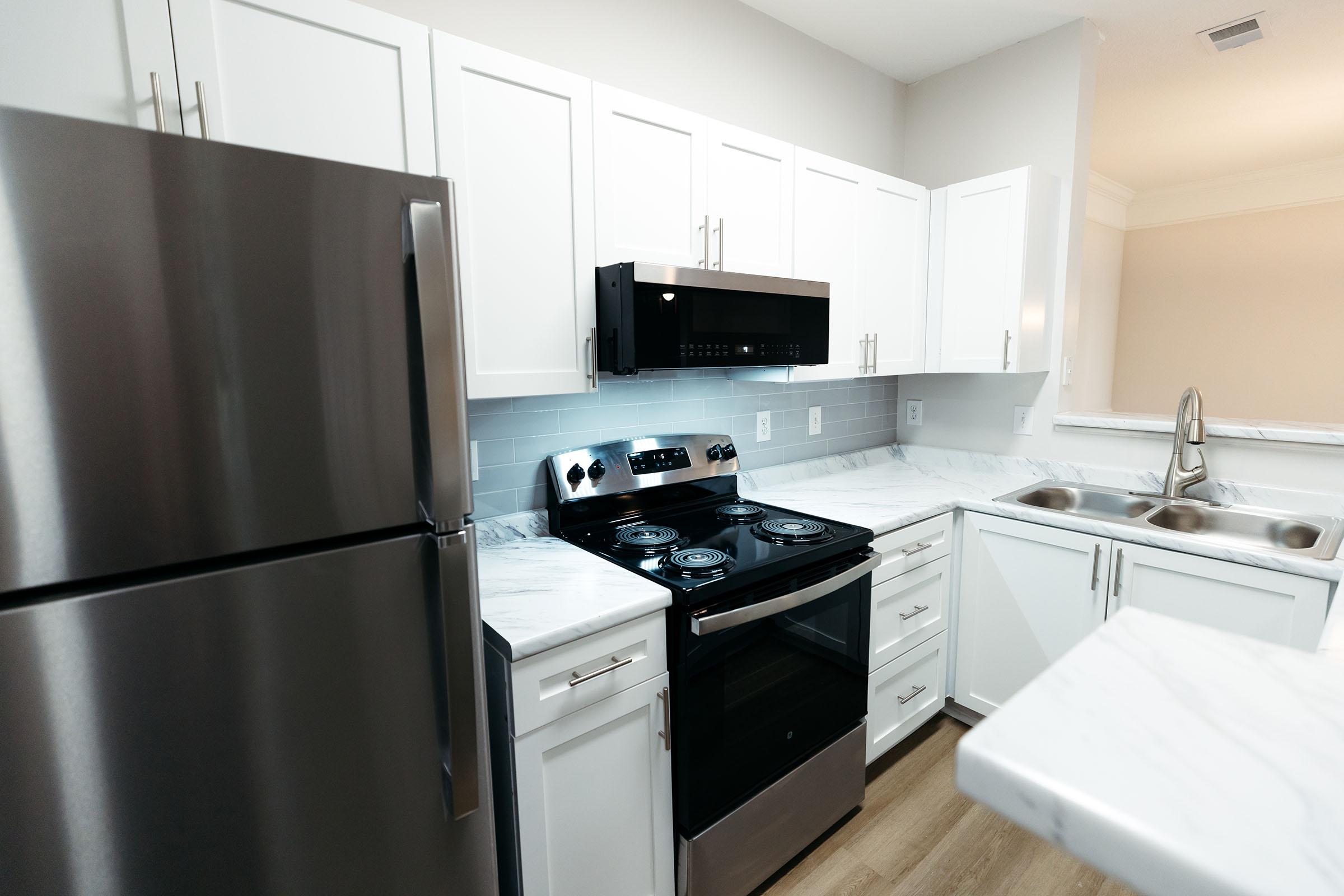 a kitchen with a stove sink and refrigerator