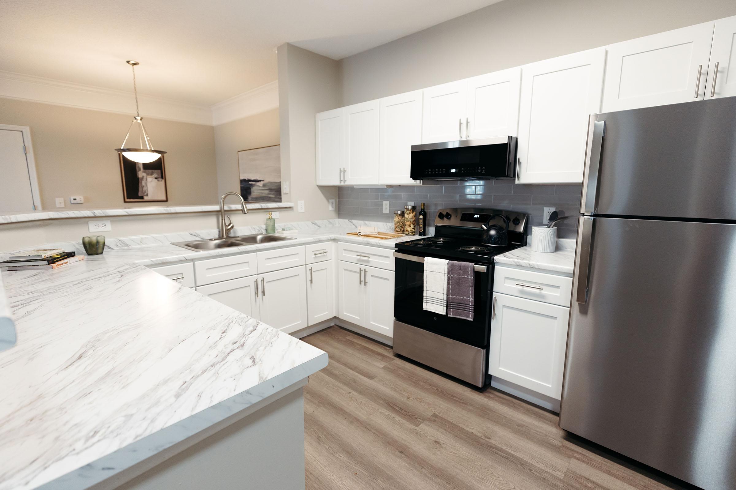 a kitchen with stainless steel appliances and wooden cabinets