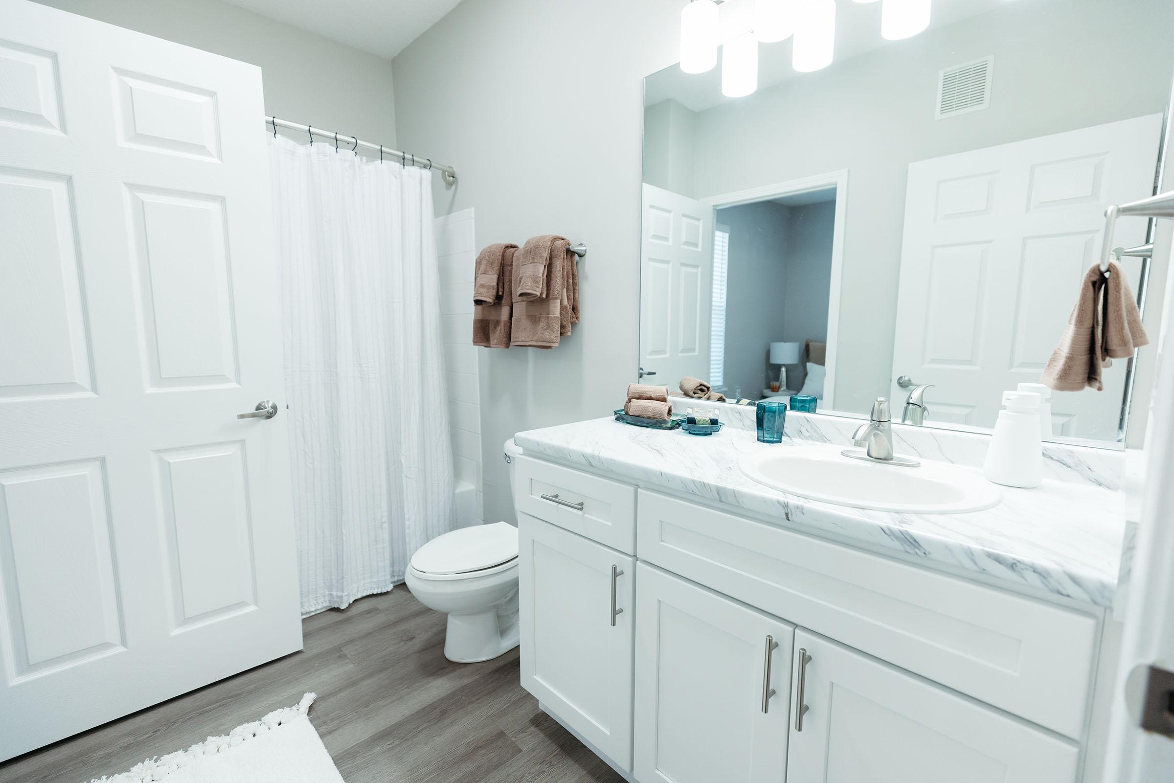 a kitchen with a sink and a mirror