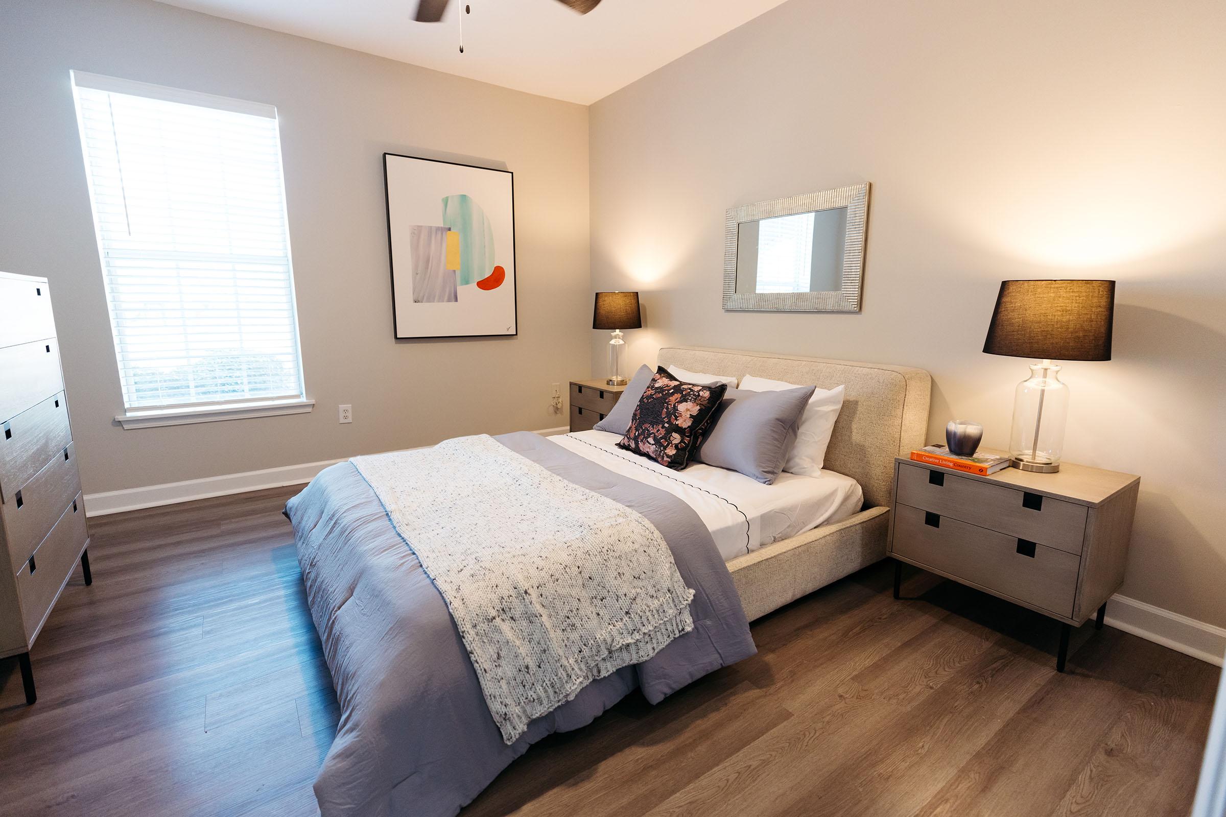 a bedroom with a bed and desk in a room