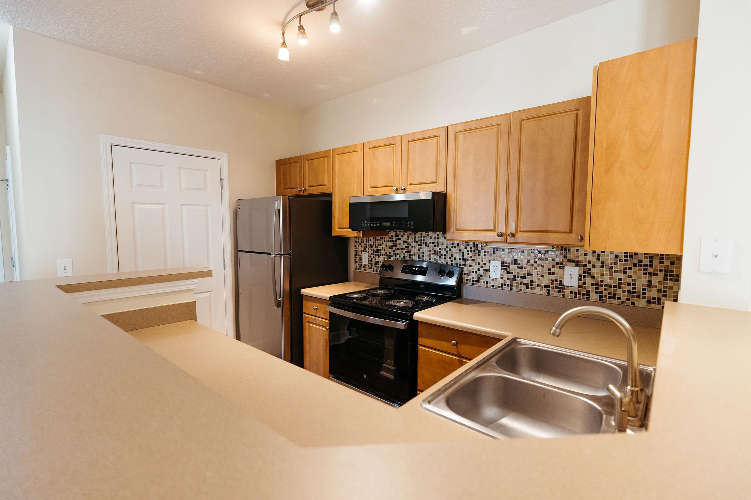 a large kitchen with stainless steel appliances