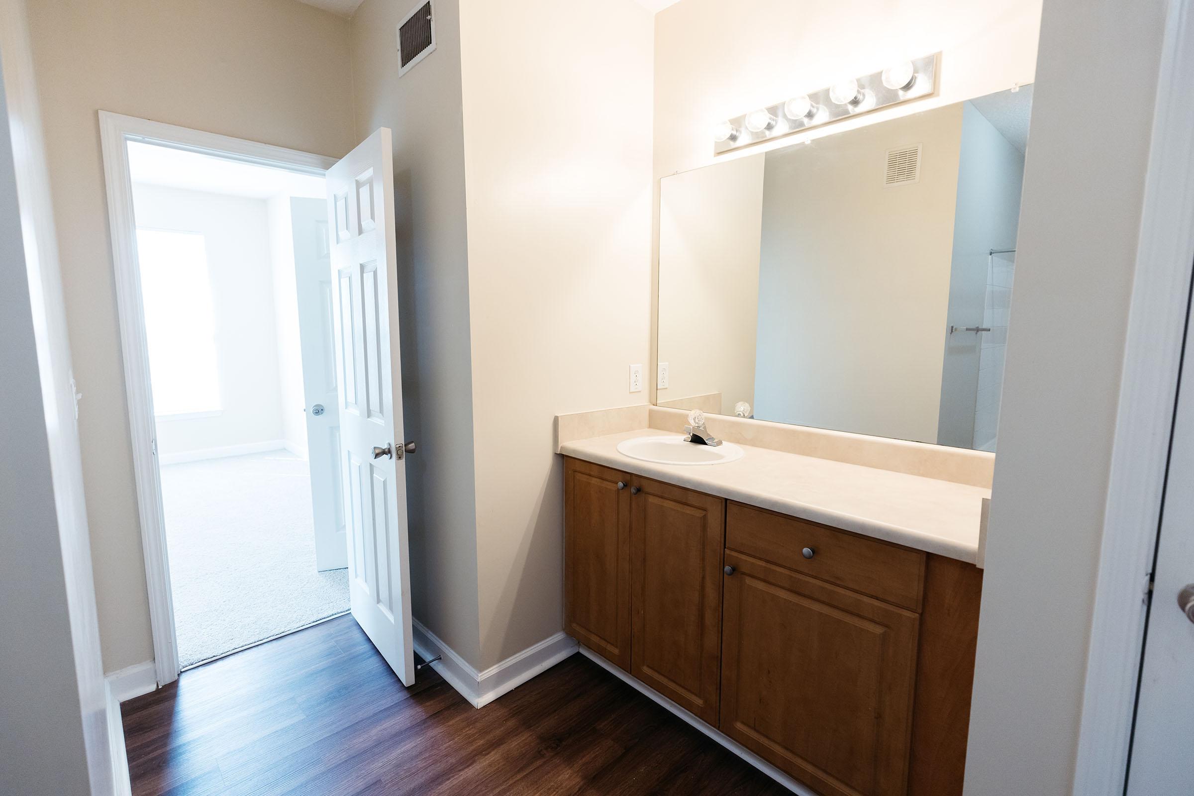 a kitchen with a sink and a mirror