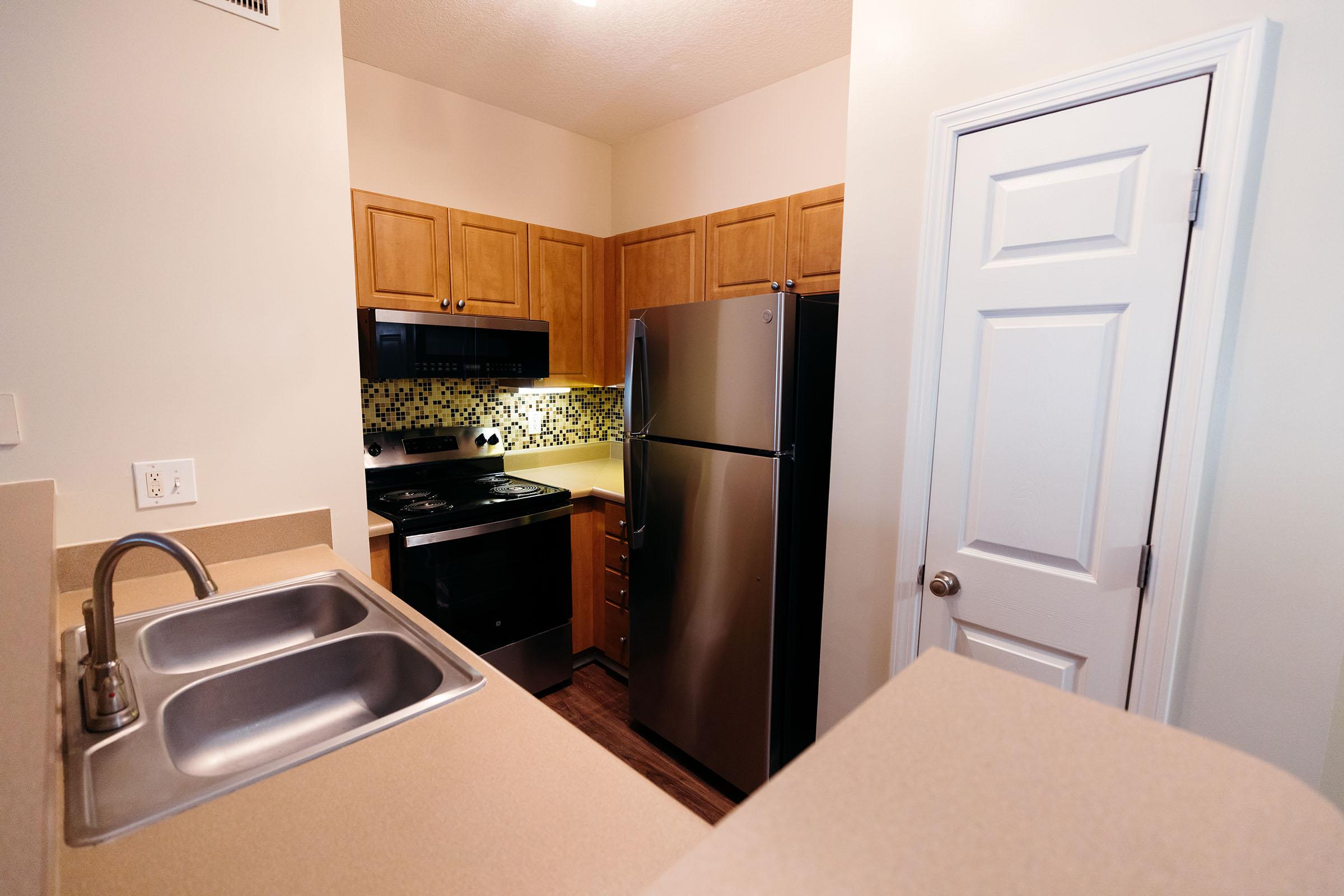 a kitchen with a sink and a refrigerator