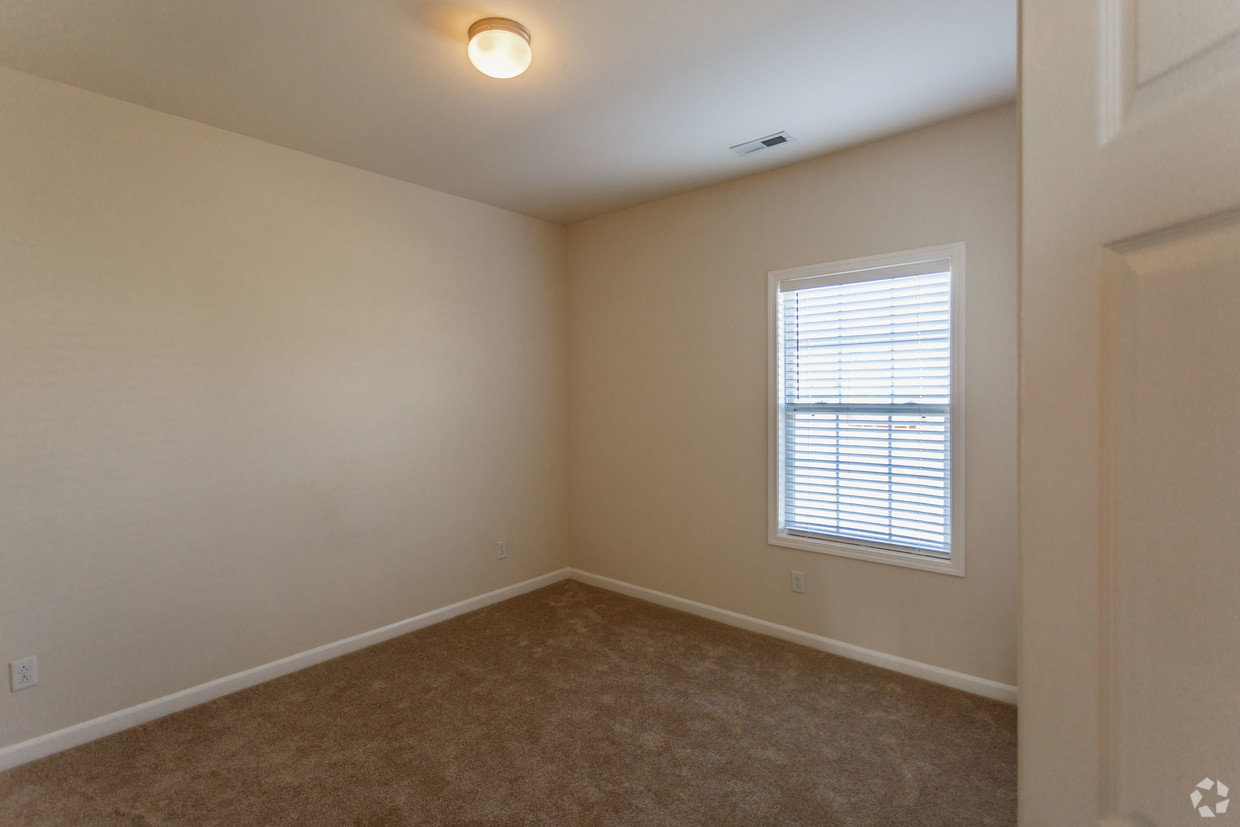 a large empty room with a sink and a window