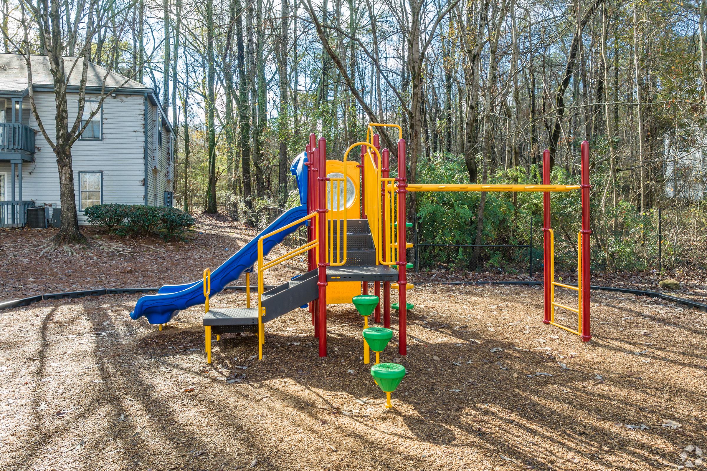 a playground in front of a fence