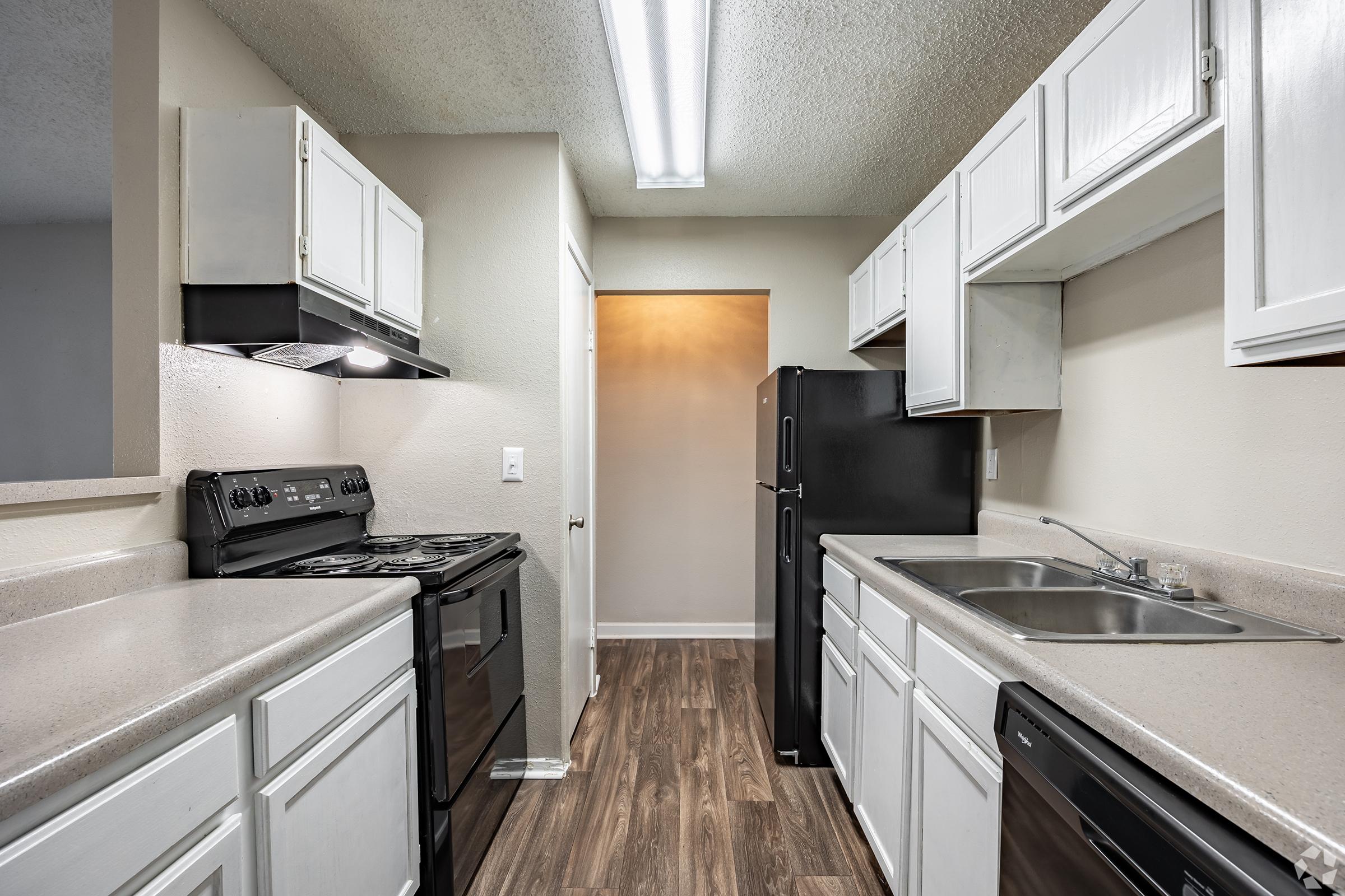 a modern kitchen with stainless steel appliances and wooden cabinets