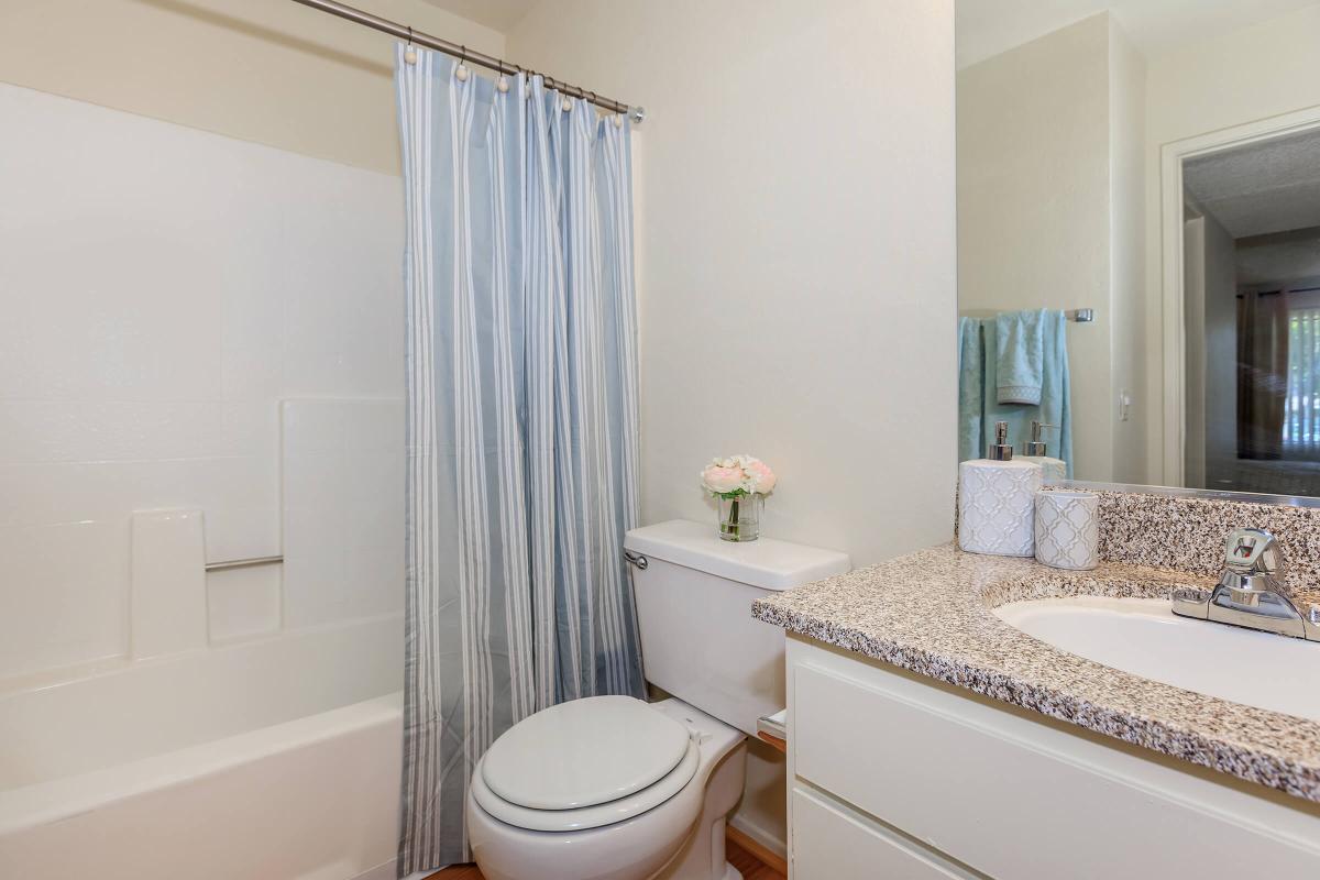 a white tub sitting next to a shower