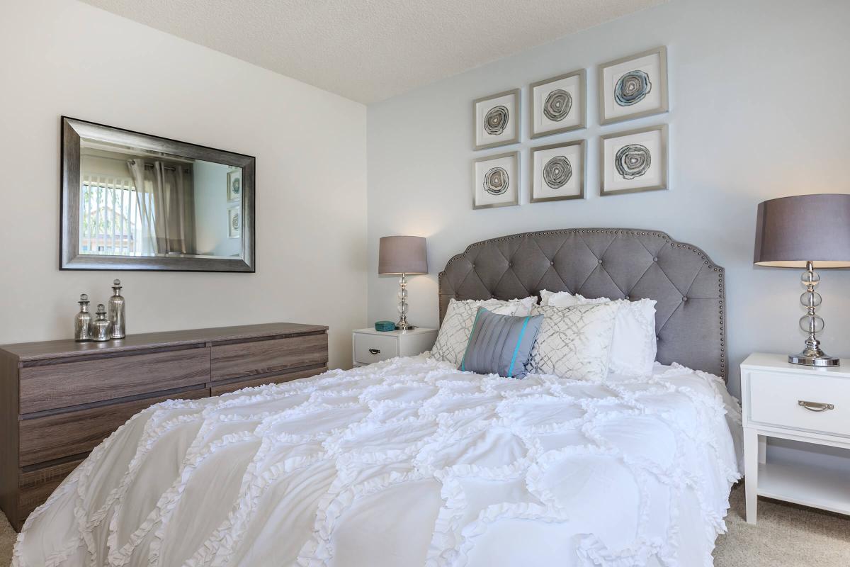 a large white bed sitting in a room