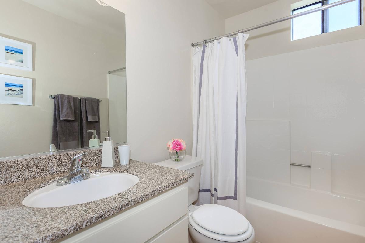 a large white tub next to a sink