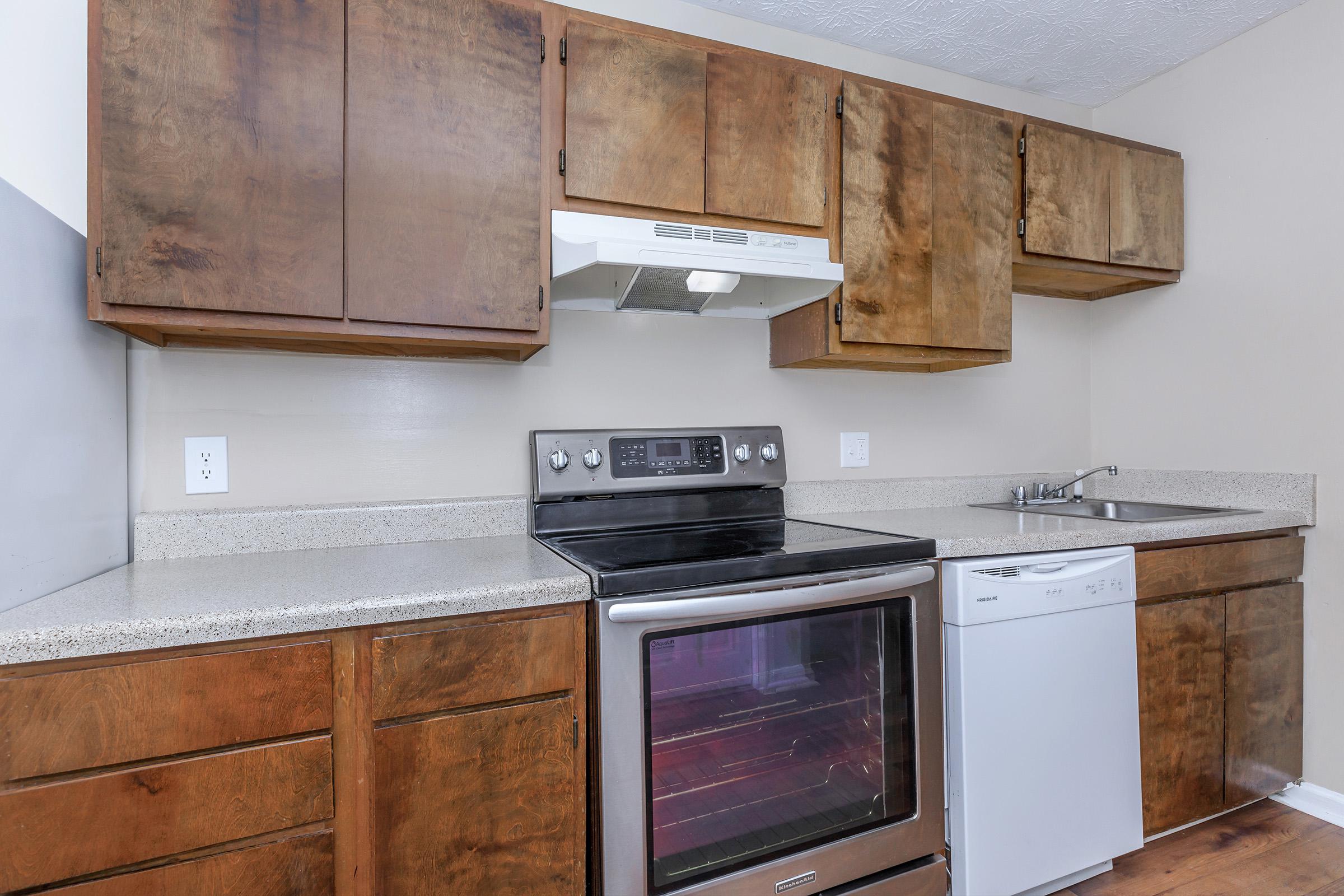 a stove top oven sitting inside of a kitchen