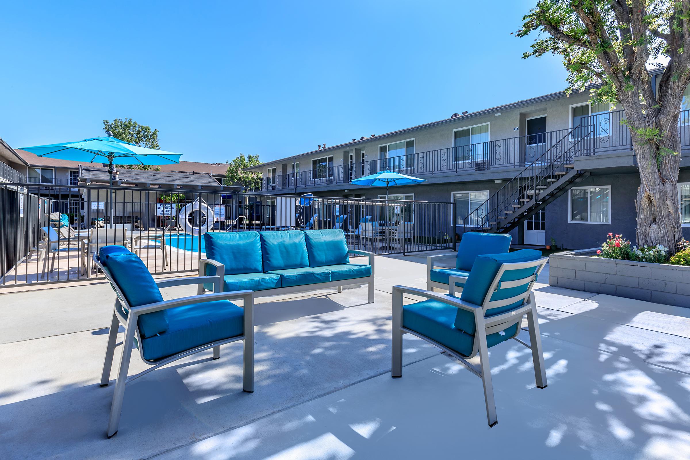 a couple of lawn chairs sitting on top of a blue chair