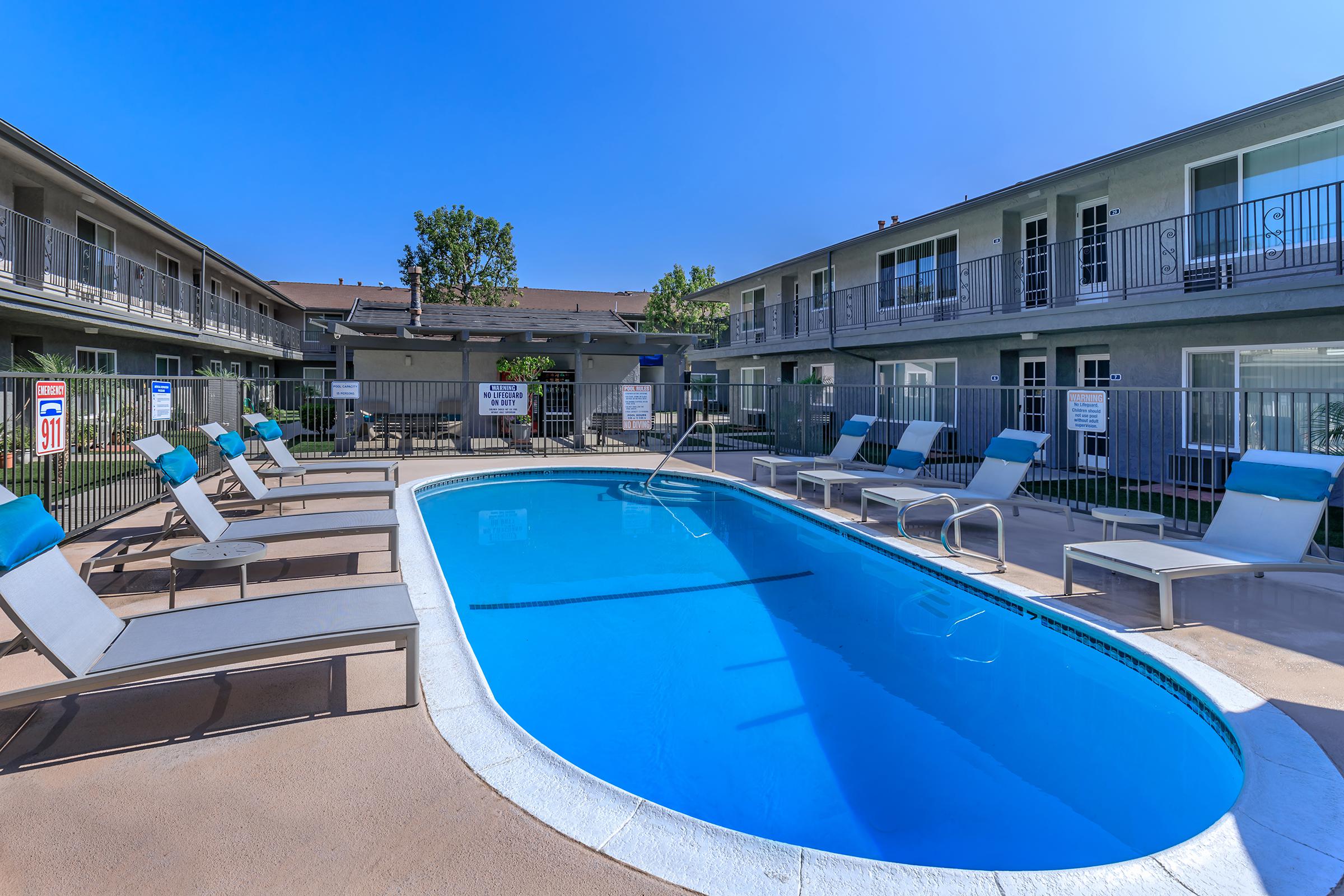 a blue pool of water in front of a building
