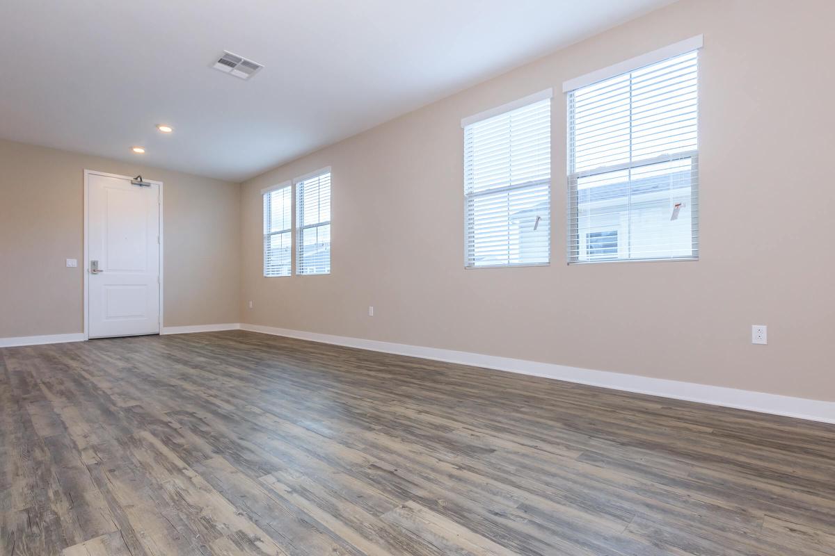 Vacant living room with wooden floors